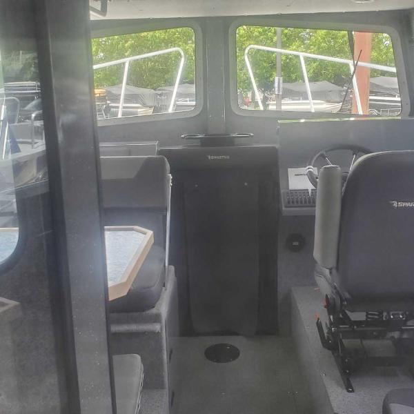 Interior of 2024 Spartan 2600 Olympia boat with seating and control area.