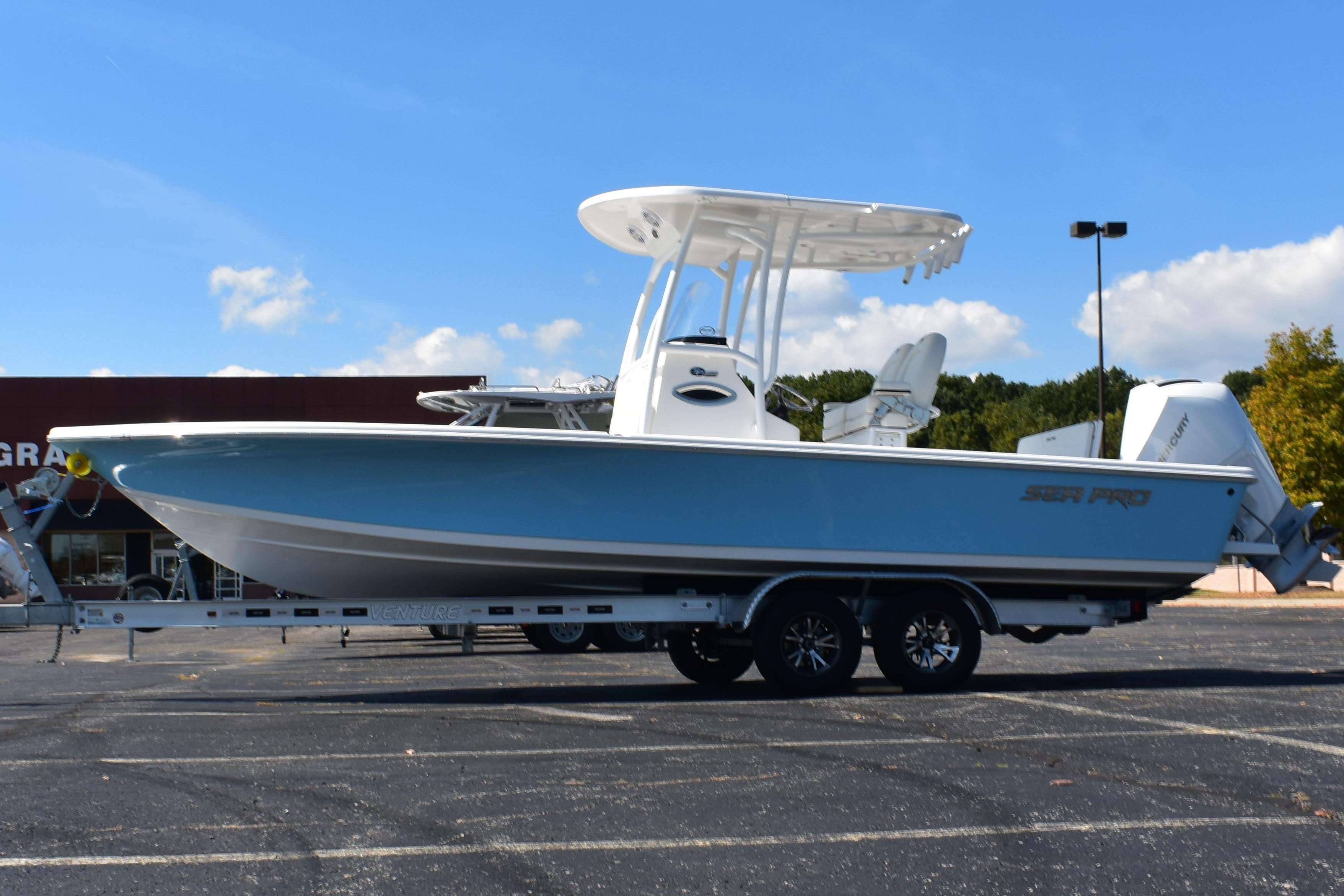2025 Sea Pro 250 Bay boat on trailer under clear blue sky.