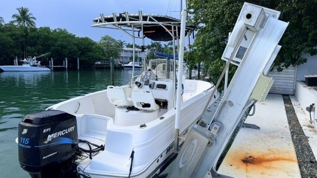 A 2004 Wellcraft 180 Fisherman is docked. It features a Mercury 115 outboard motor.