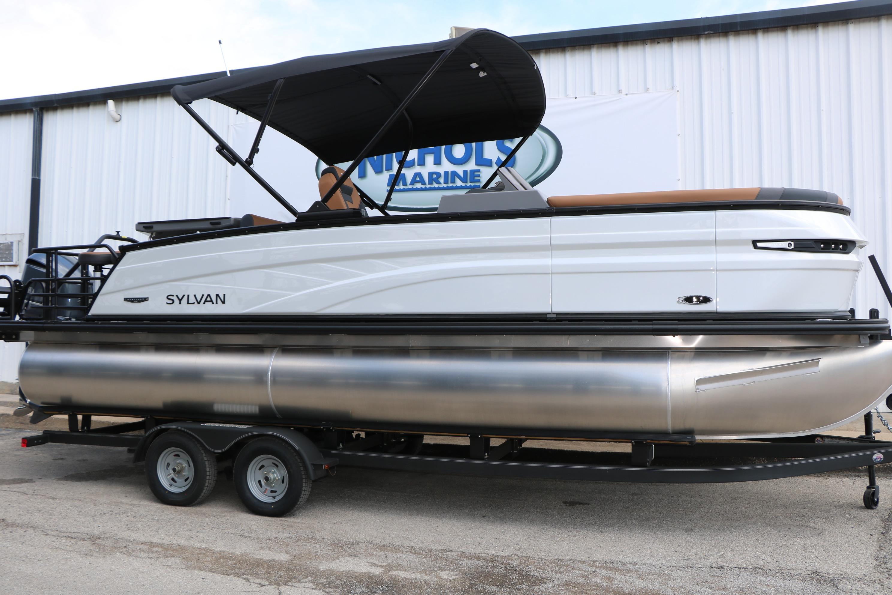 2026 Sylvan L3 DLZ Bar Platinum Edition Tri-Toon boat on trailer, side view.