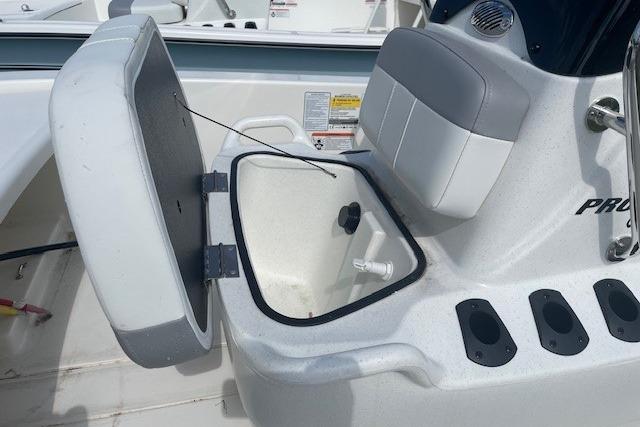 2026 Mako Pro Skiff 13 CC boat seat with storage compartment open.