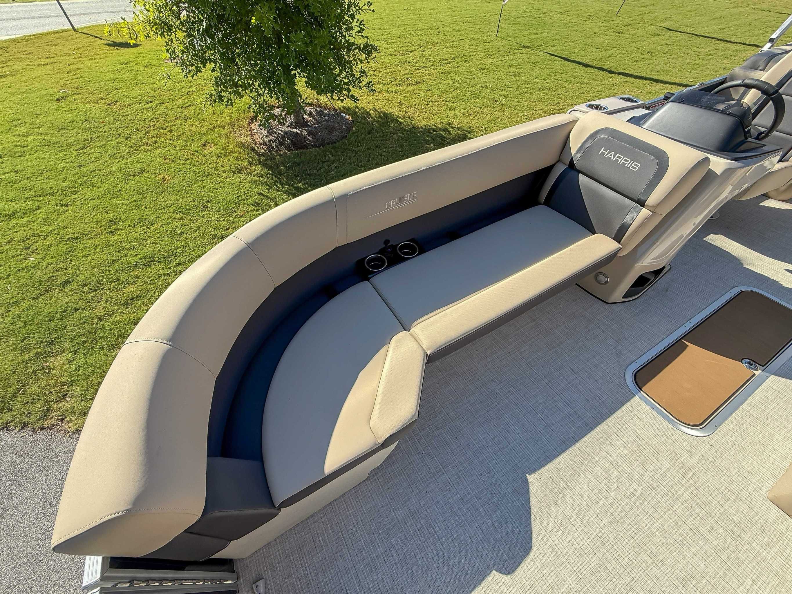 2025 Harris Cruiser 250 CWDH with beige seating on green lawn.