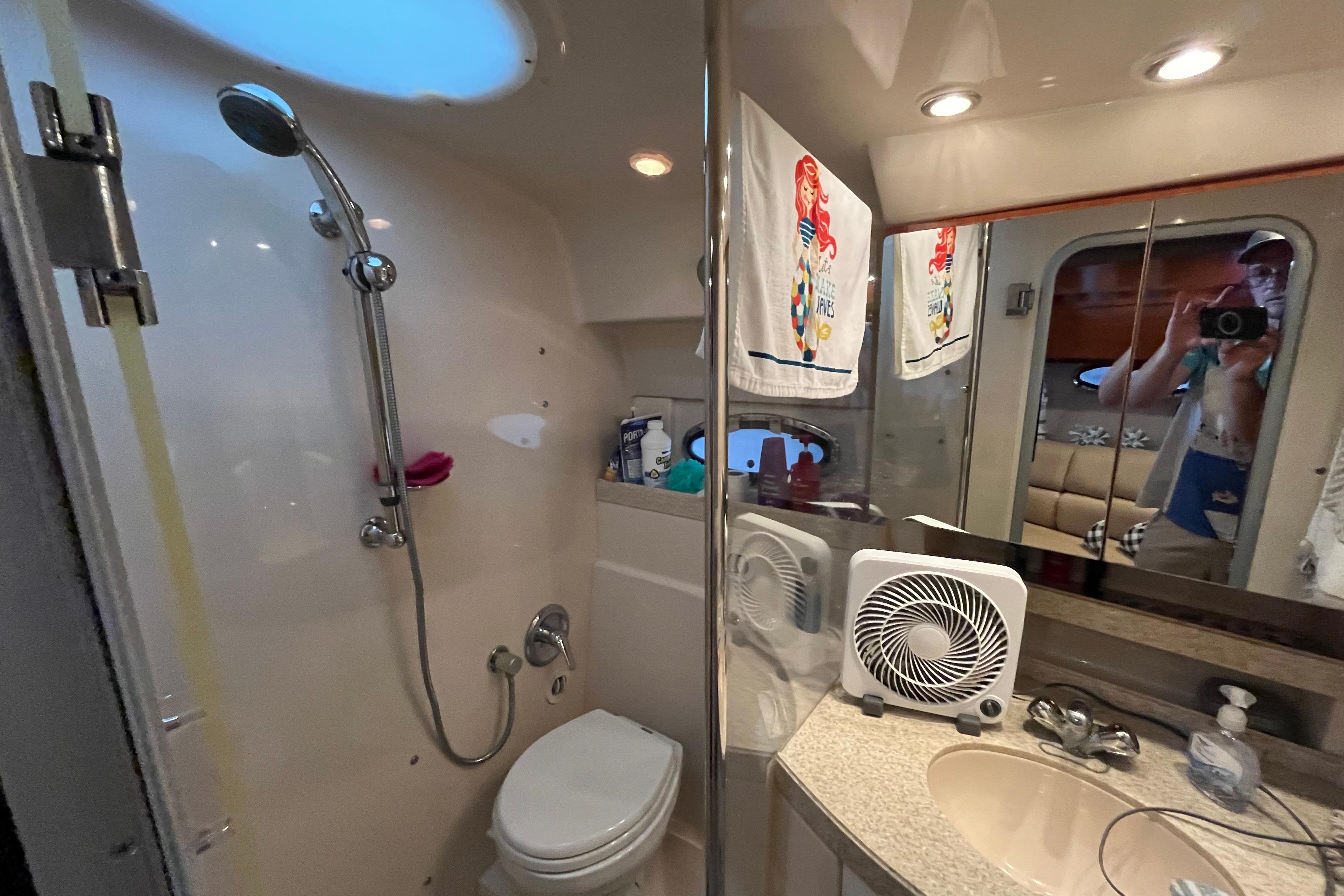Bathroom interior of 2007 Regal 3760 IB Commodore yacht with shower and sink.