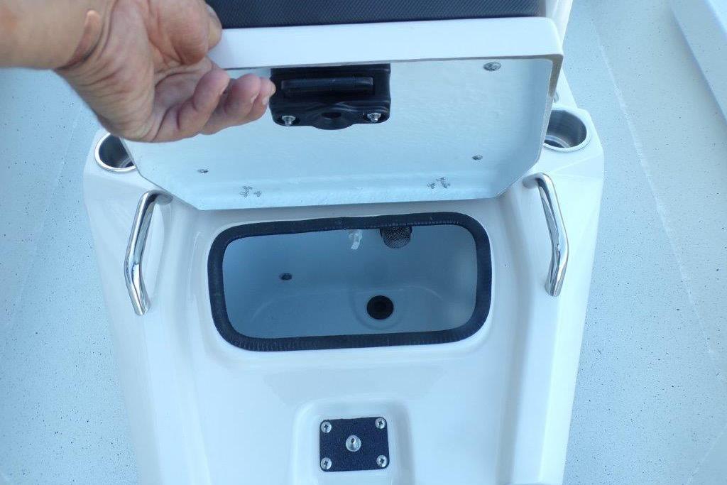 Open storage compartment on 2026 Xpress H20B Bay boat with hand lifting lid.