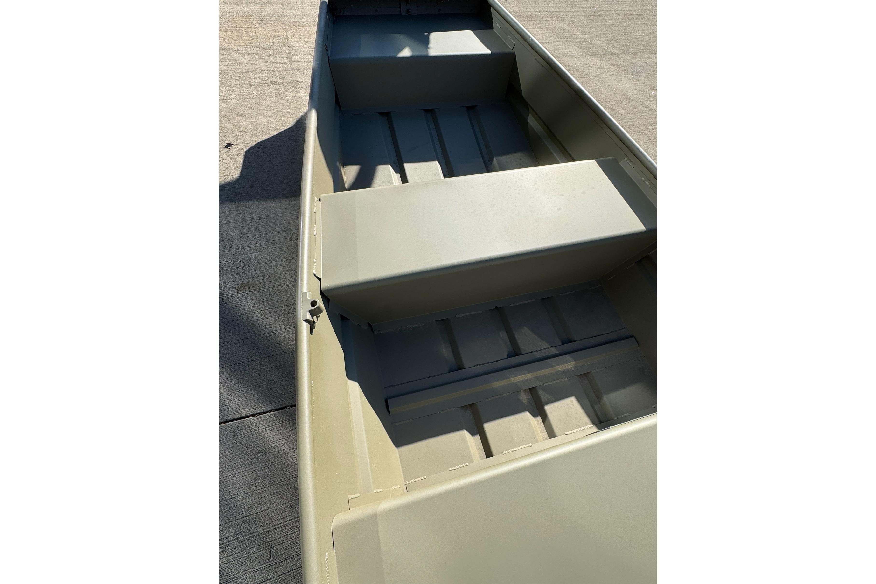 2026 Tracker Grizzly 10 Jon boat interior with bench seats, shown on concrete surface.