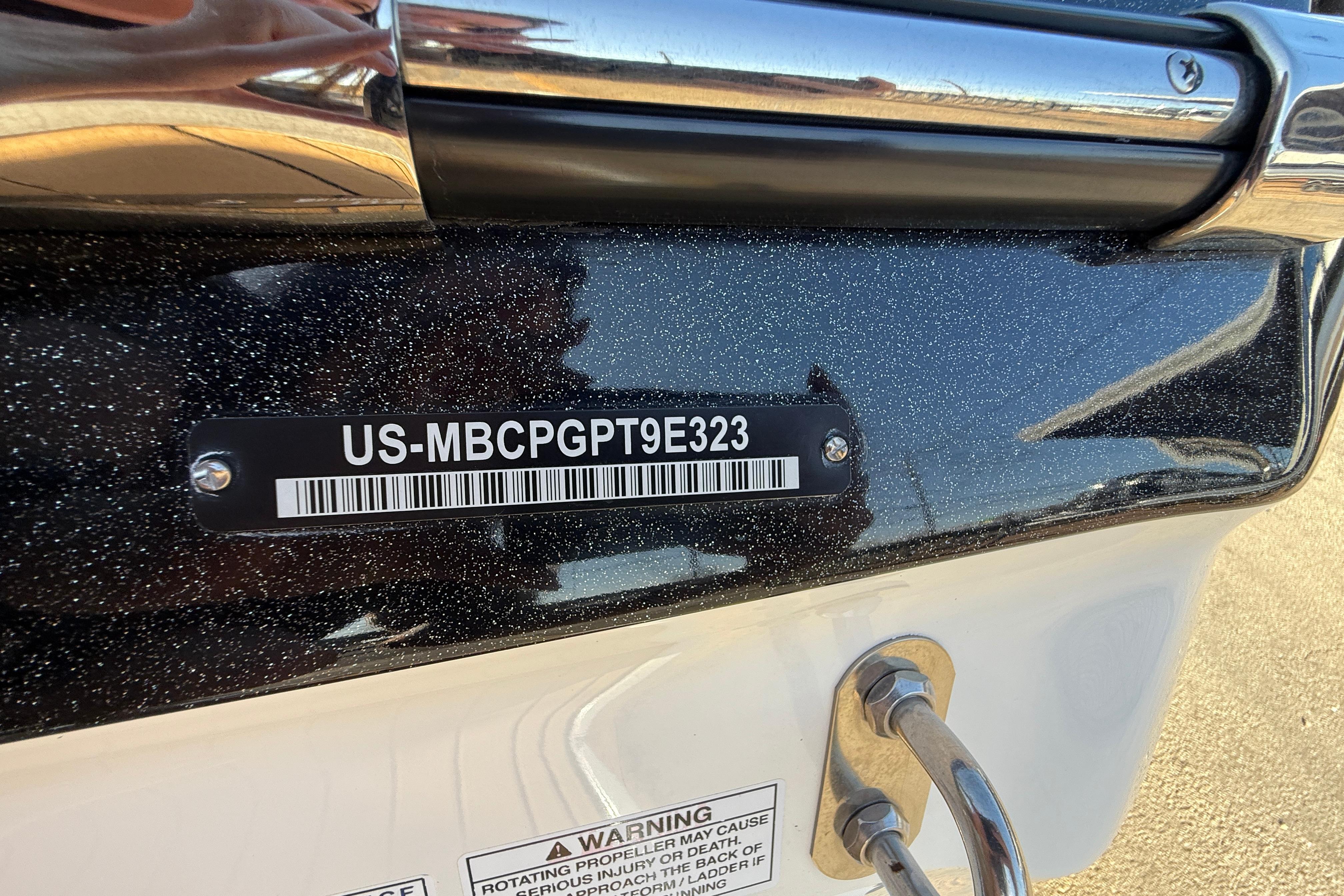 2023 MasterCraft X22 boat with visible hull identification number and warning label.