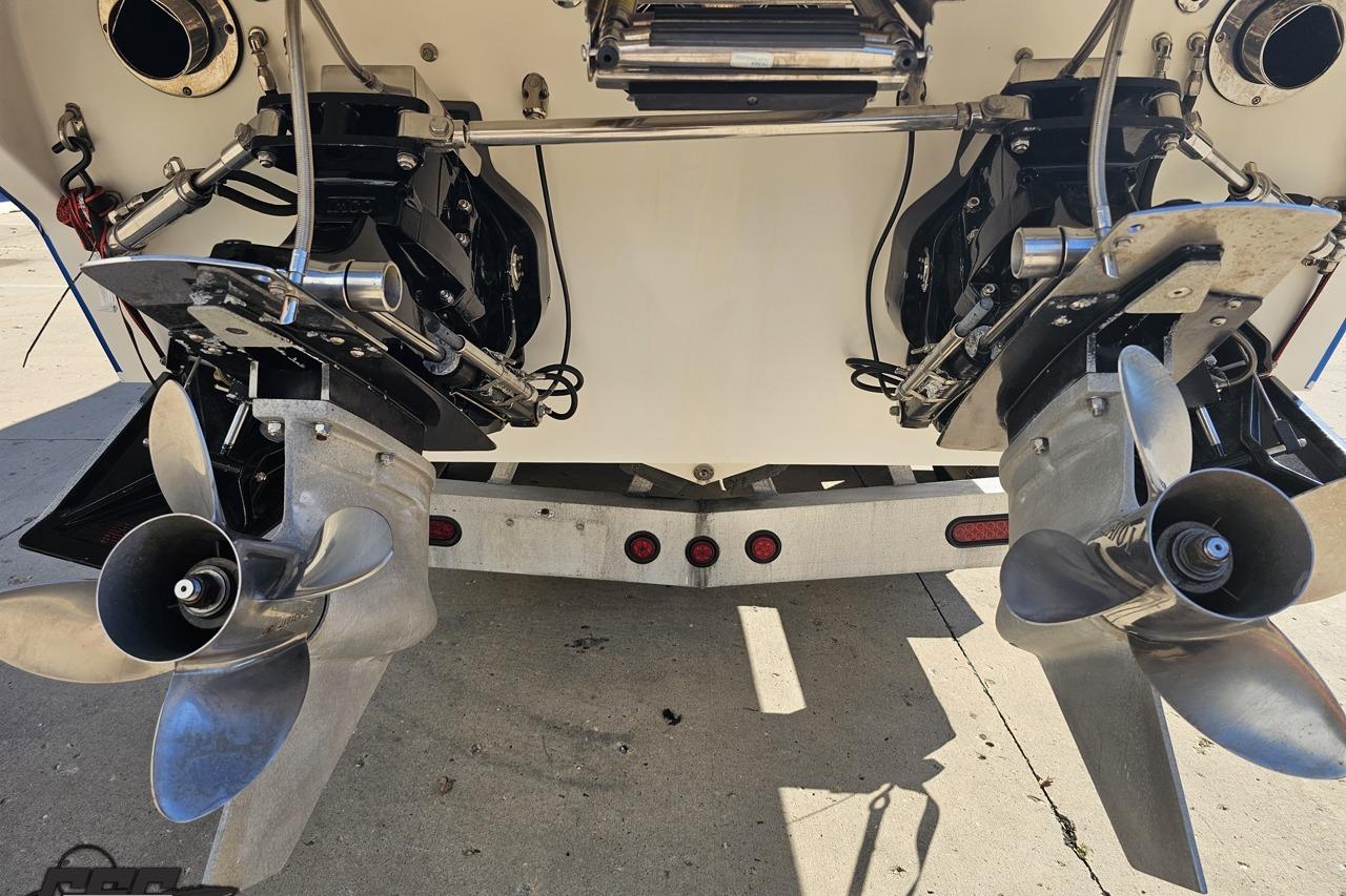 Dual propellers of a 2002 Hustler 388 SLINGSHOT boat on a trailer.