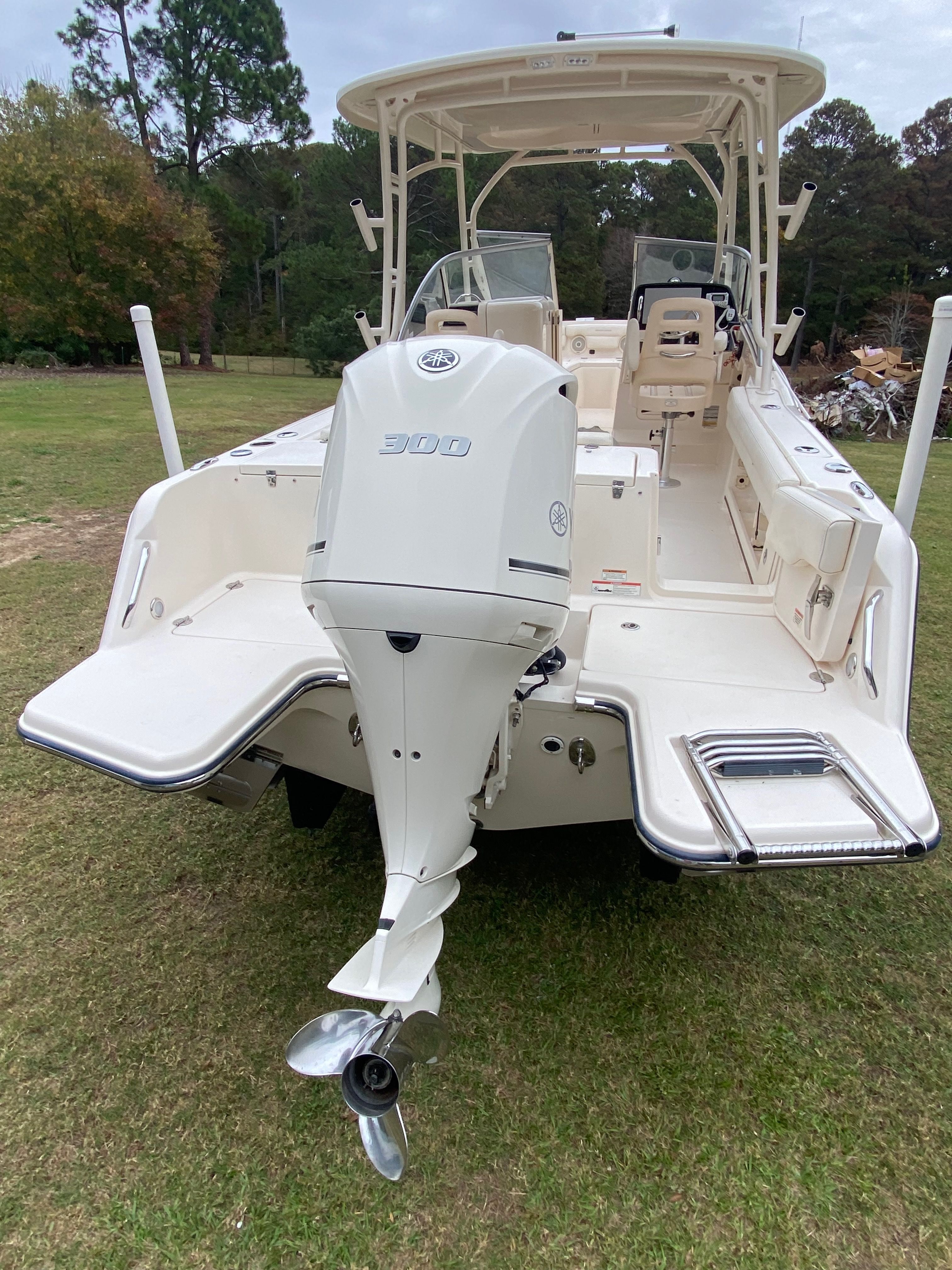 2018 Grady-White Freedom235 boat with outboard motor on grass.