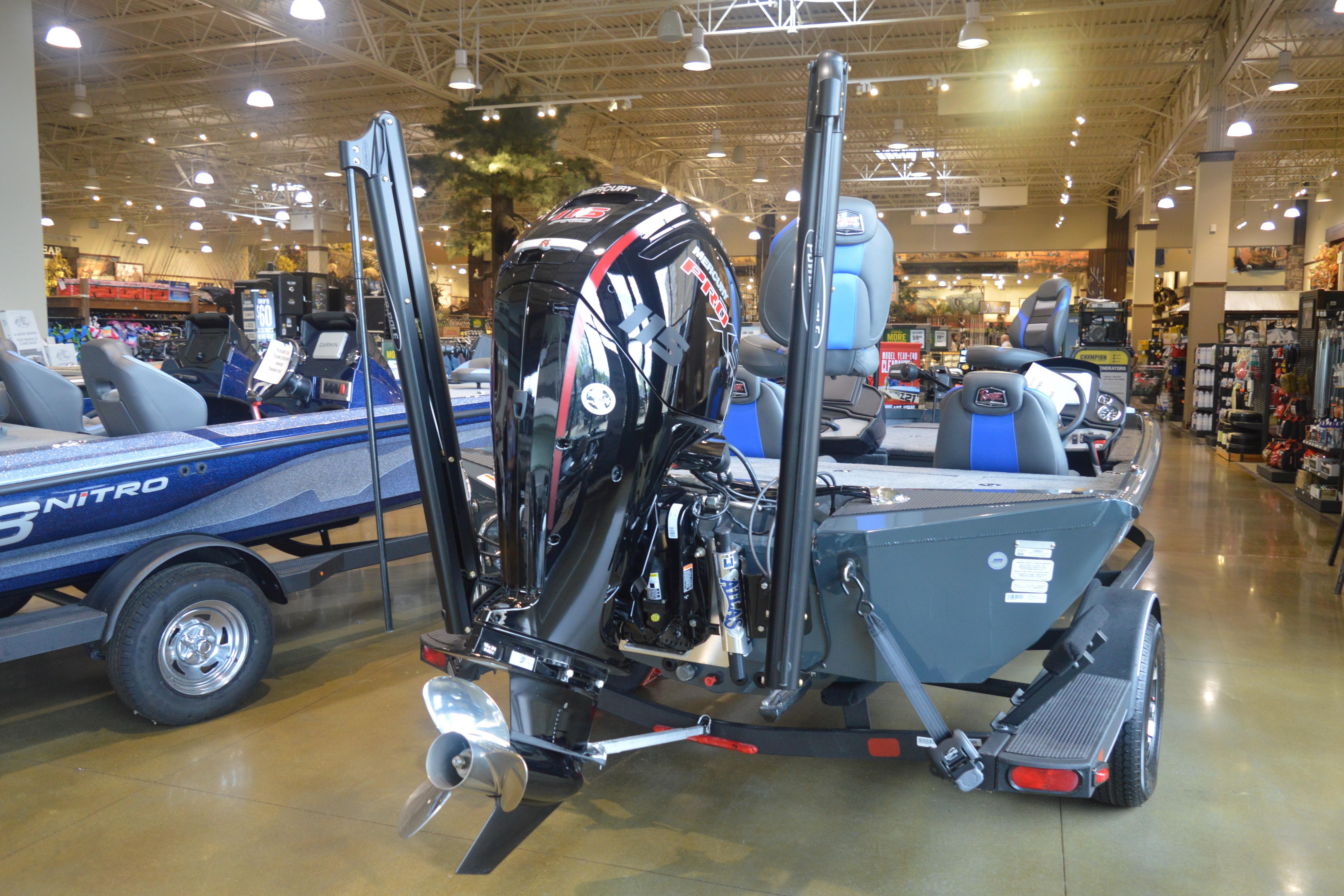 2026 Ranger RT188P boat displayed indoors with powerful outboard motor.