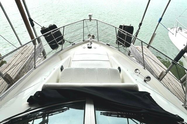 2004 Carver 360 Mariner yacht bow view with railing and water backdrop.