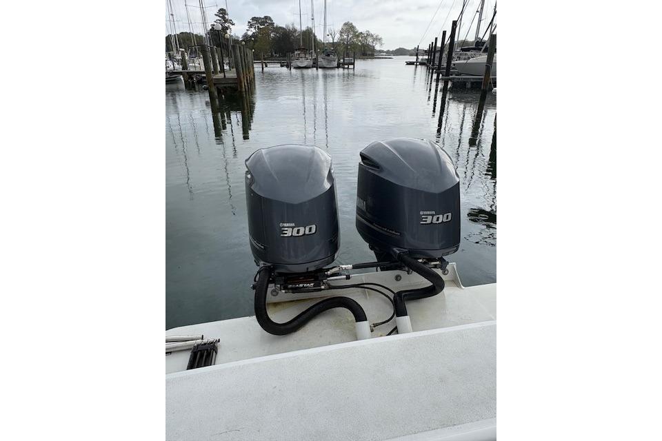 Twin Yamaha 300 outboard motors on a 1989 C-Hawk 29 Sport Cabin boat at a marina.