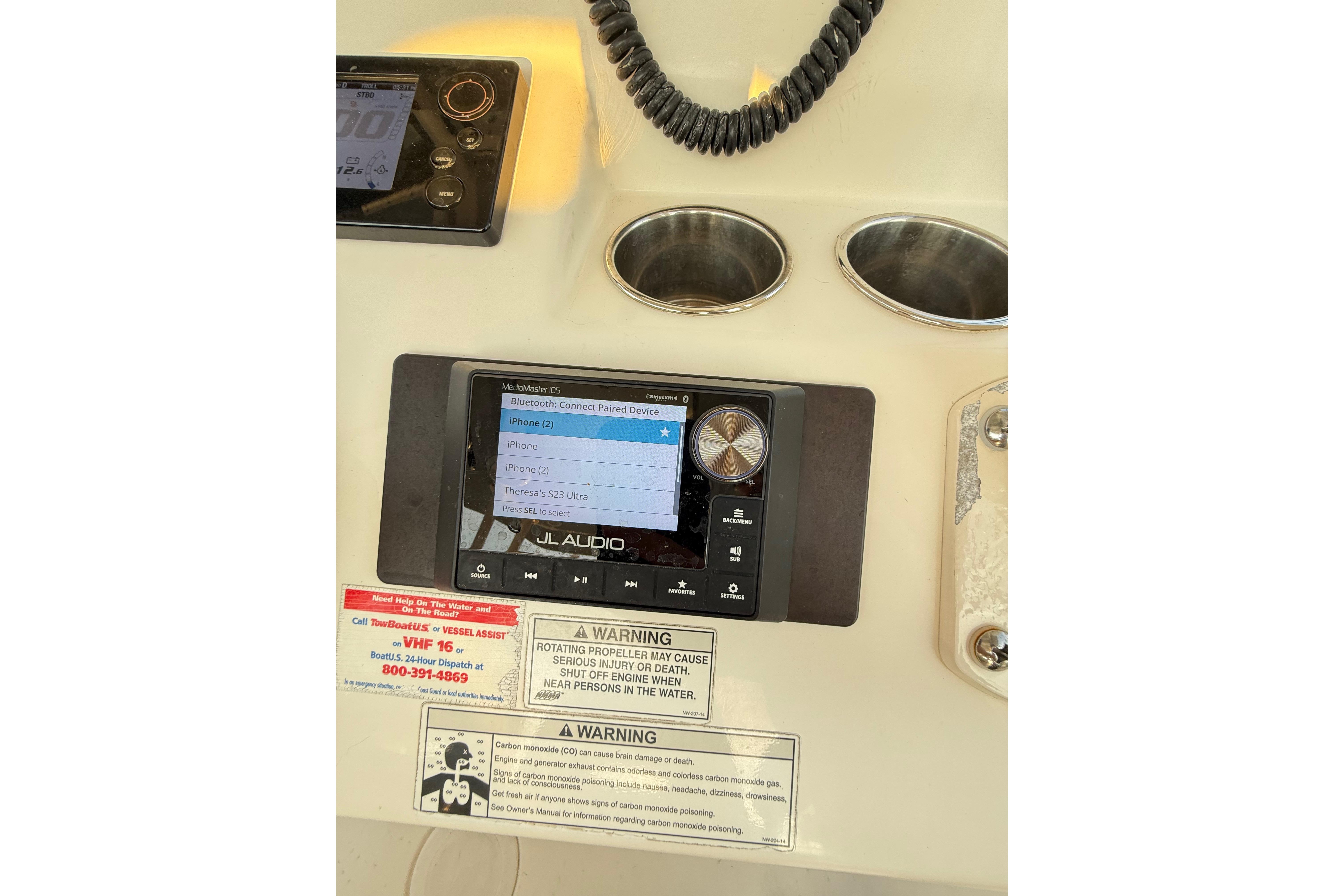Control panel of a 2016 Cobia 296 Center Console boat with Bluetooth connectivity.