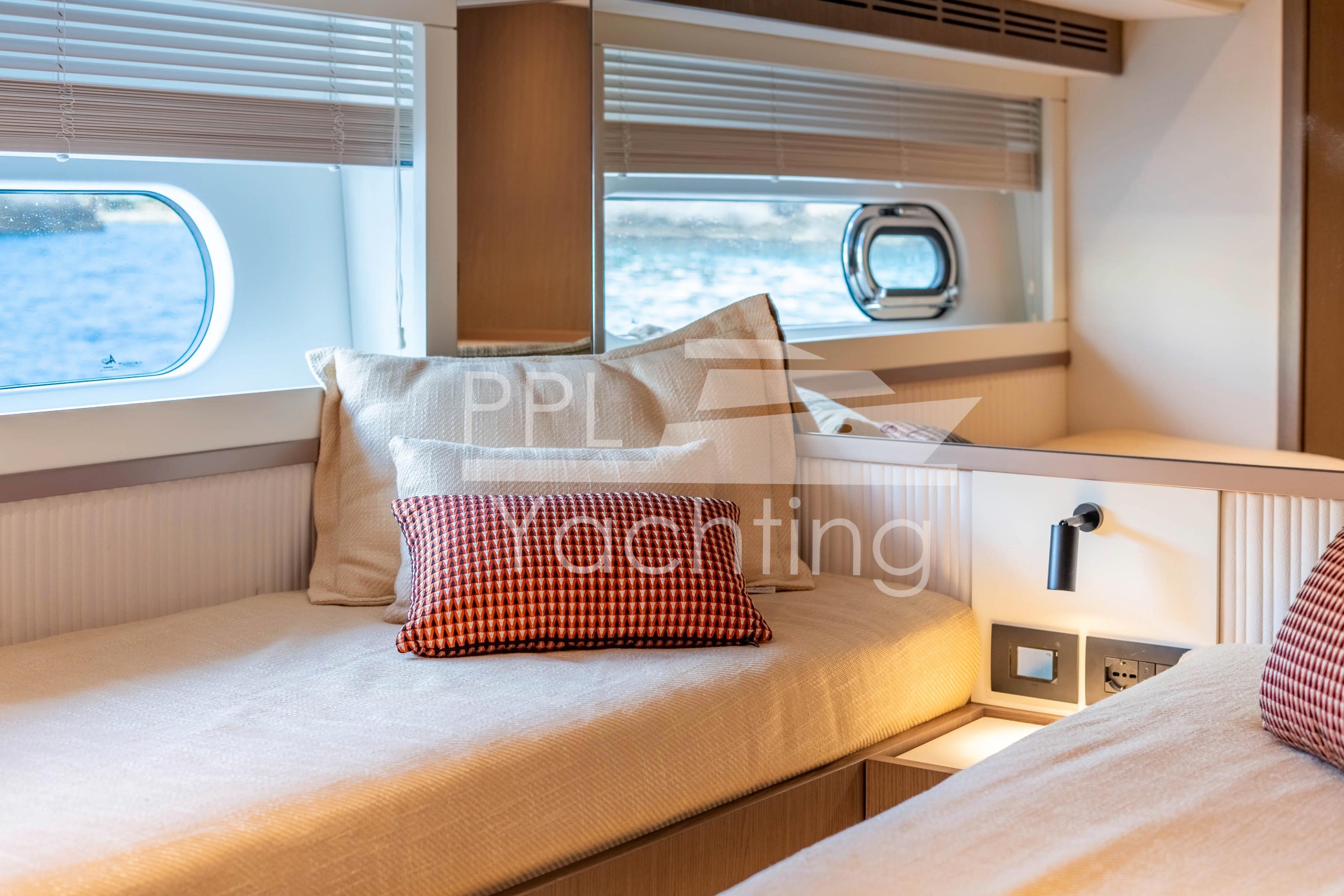 Interior of 2021 Azimut Magellano 66 yacht with cozy seating and ocean view.