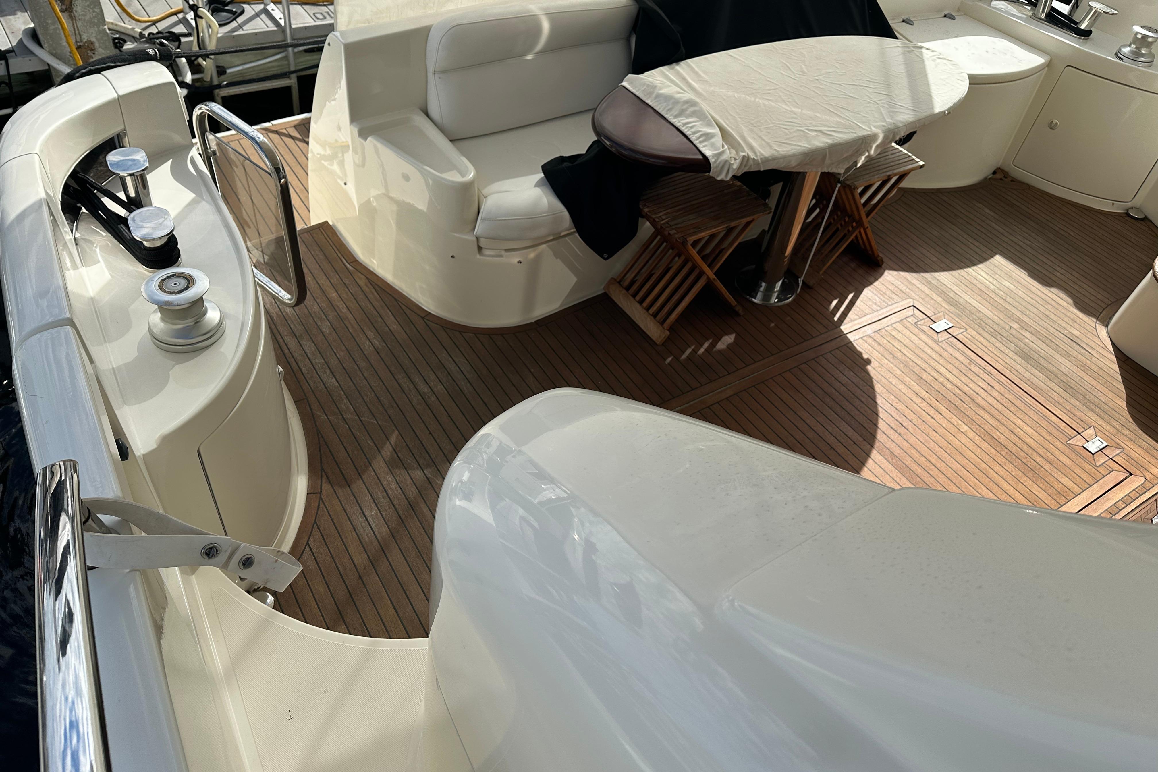 Luxurious 2004 Azimut 55E yacht deck with seating and table.