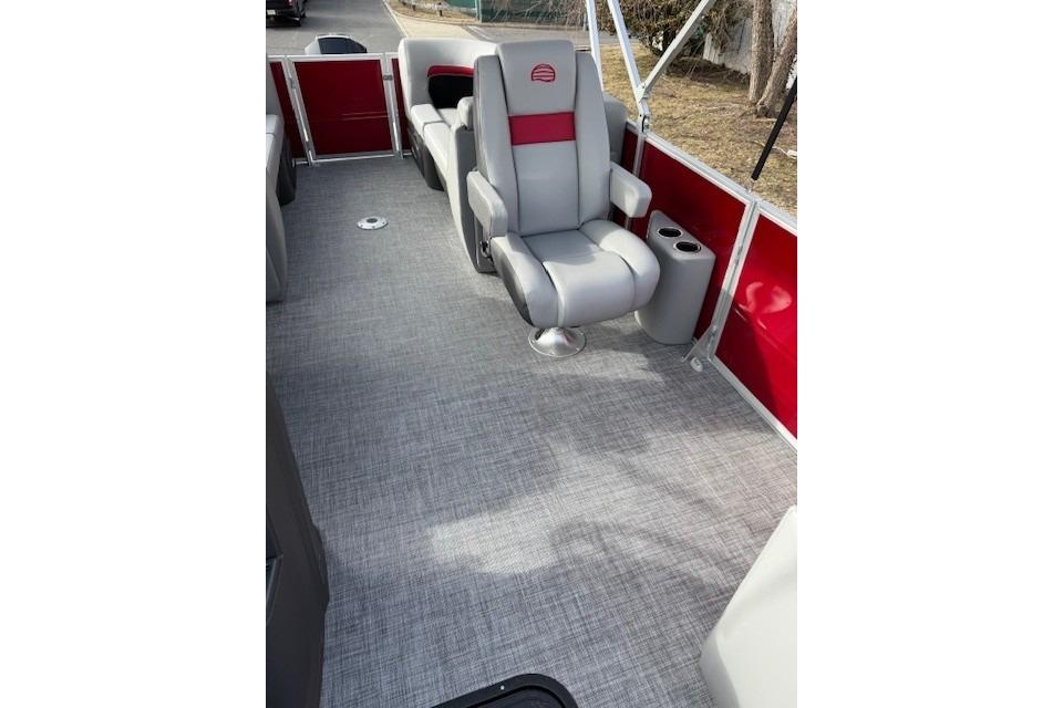 2026 Sun Tracker Party Barge 24 XP3 interior with gray seating and red accents.