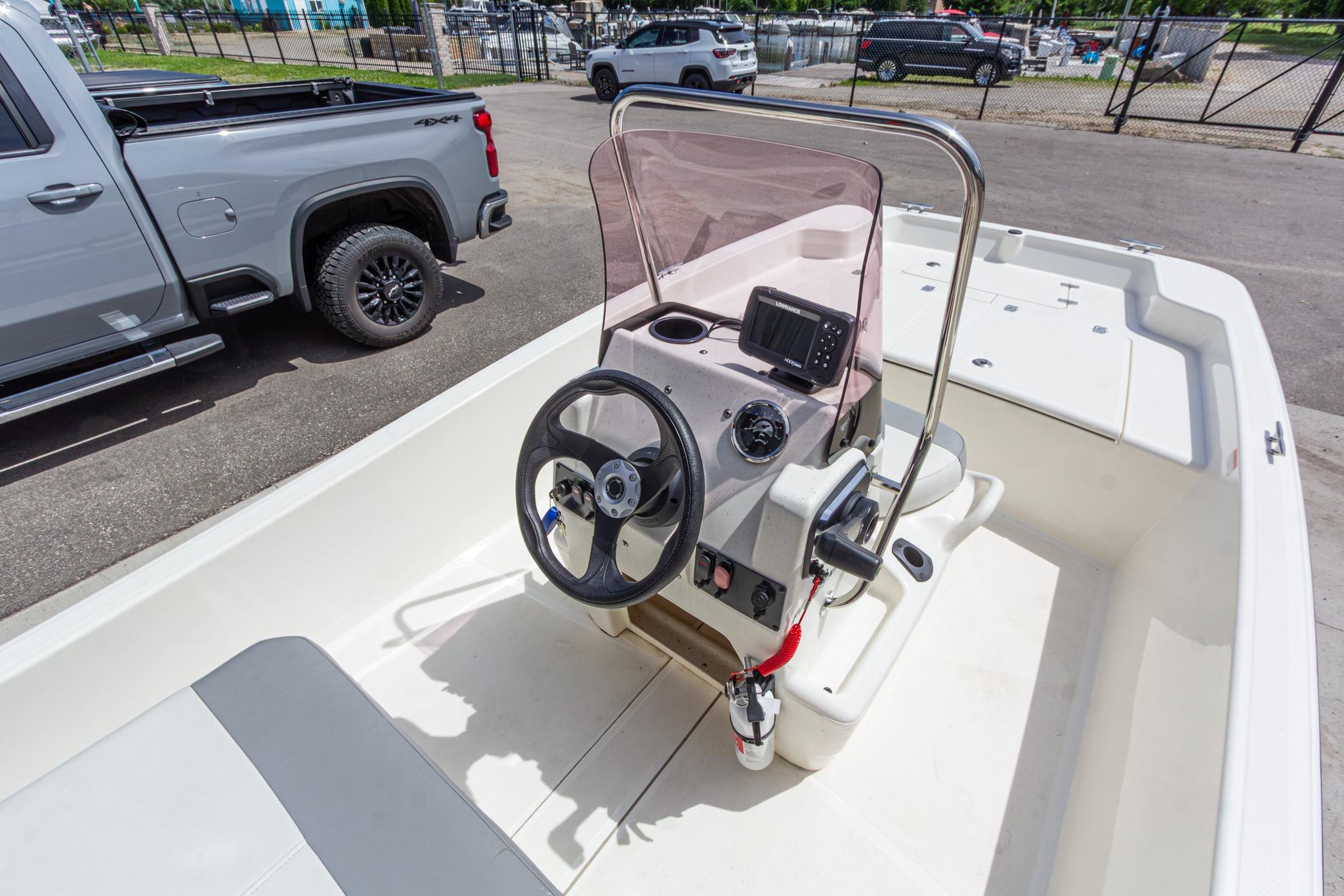 2020 Mako Pro Skiff 15 CC boat interior with steering console and seating.