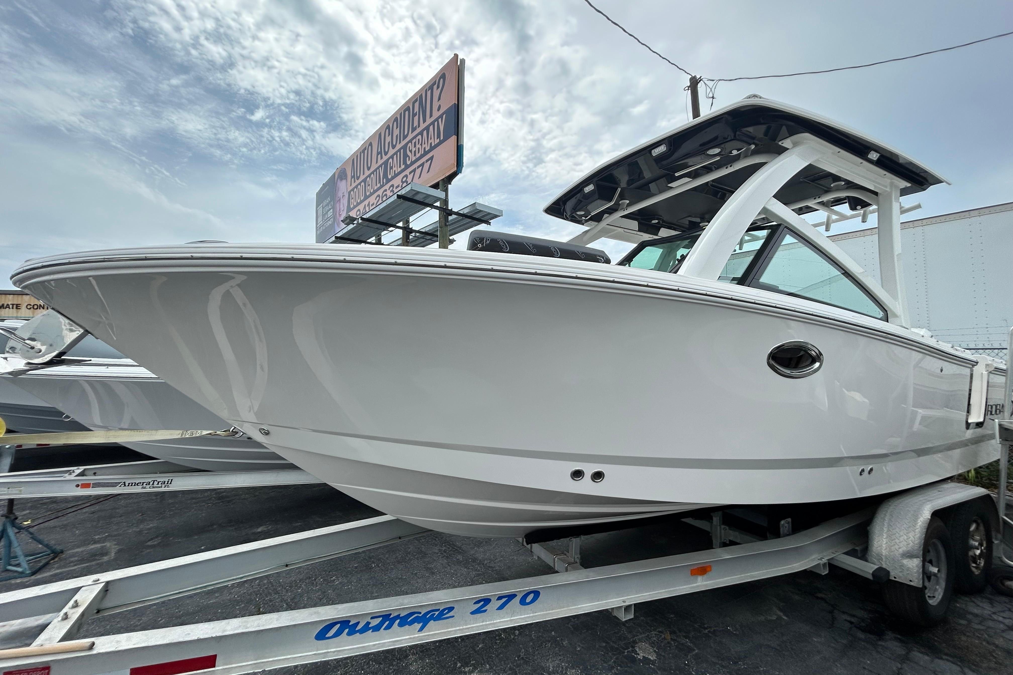 2026 Robalo R257 Dual Console boat on trailer under cloudy sky.