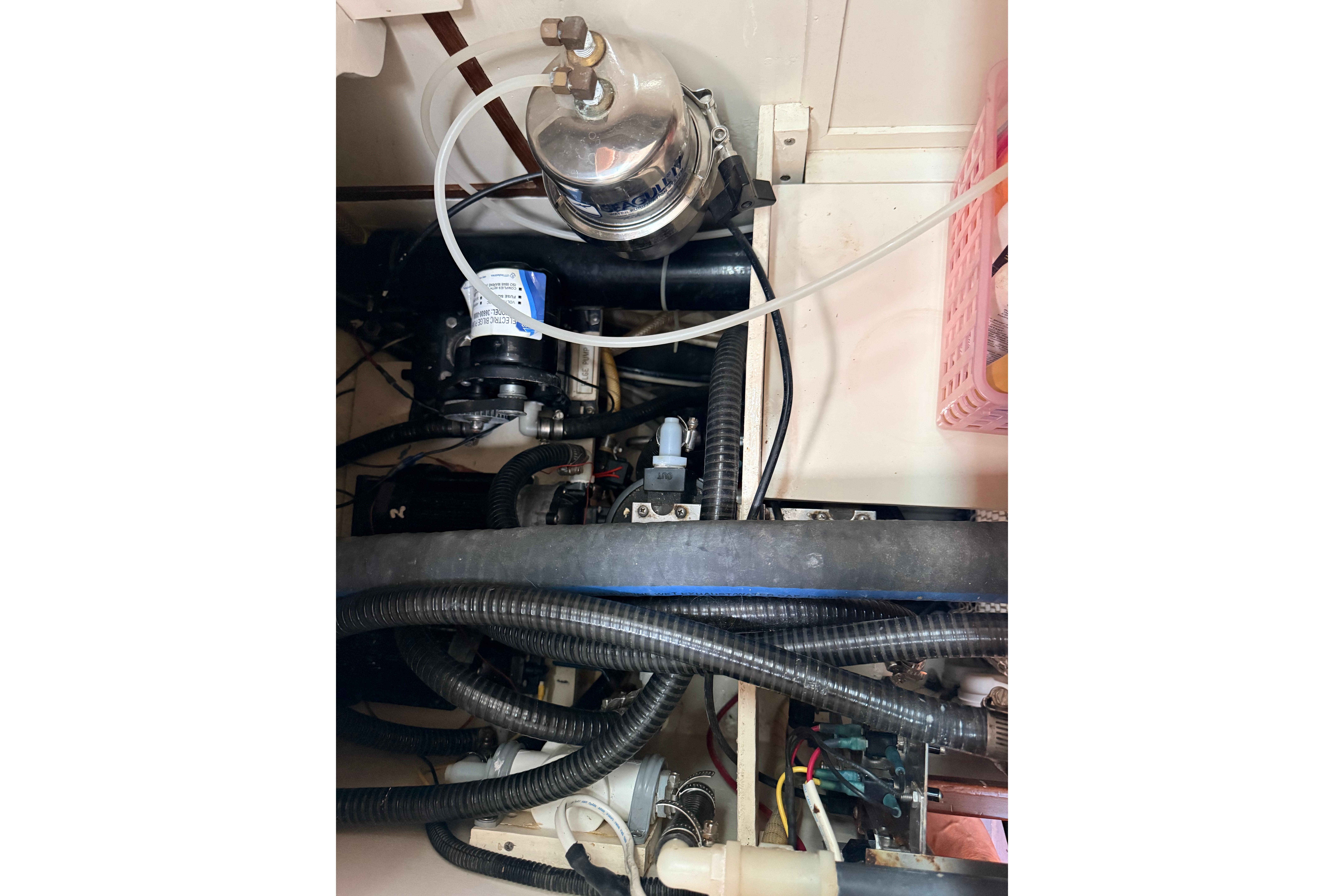 Engine compartment of a 1987 Norseman 400, showcasing hoses and mechanical components.