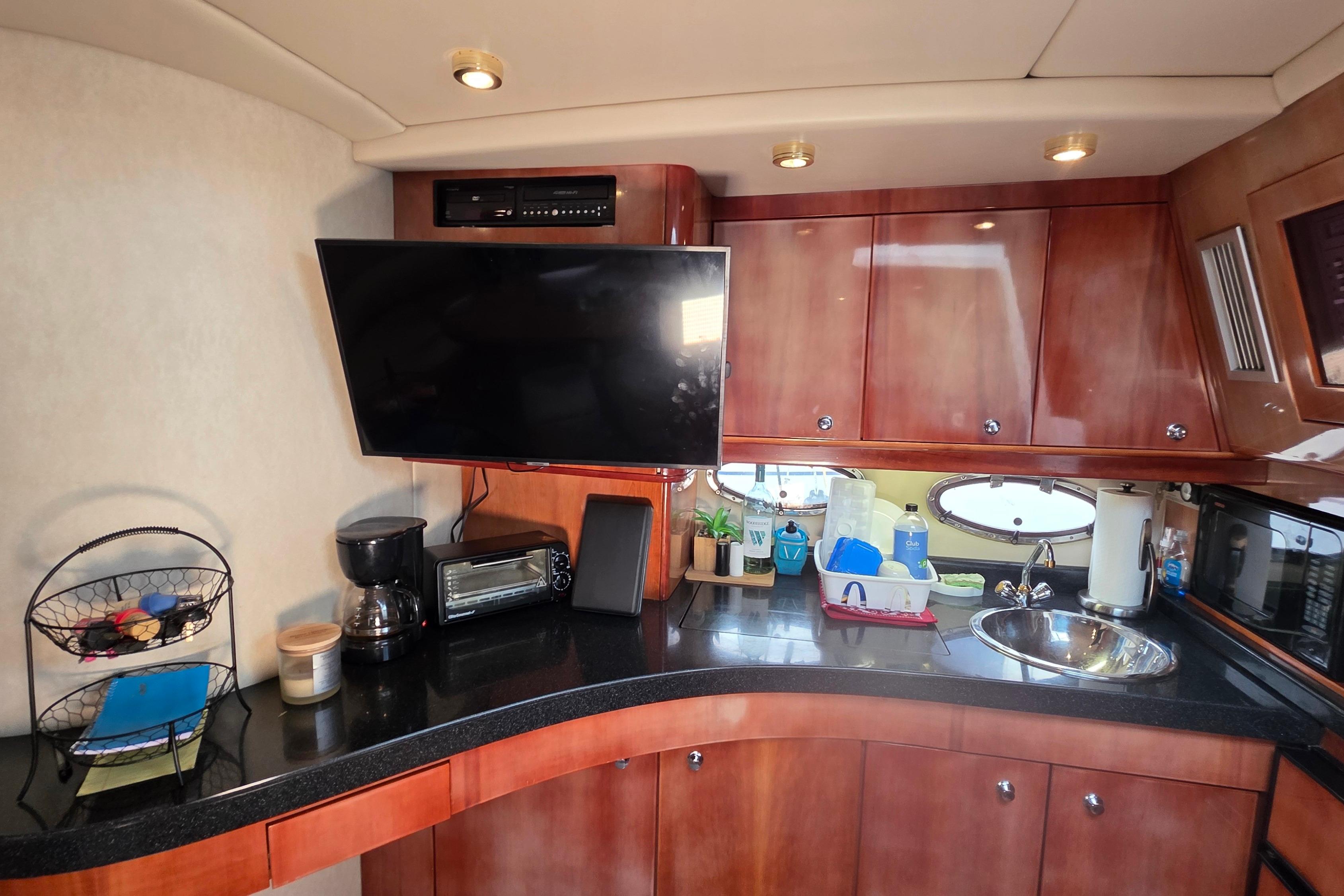 Luxurious 2002 Regal Commodore 4260 yacht interior with modern kitchen amenities.