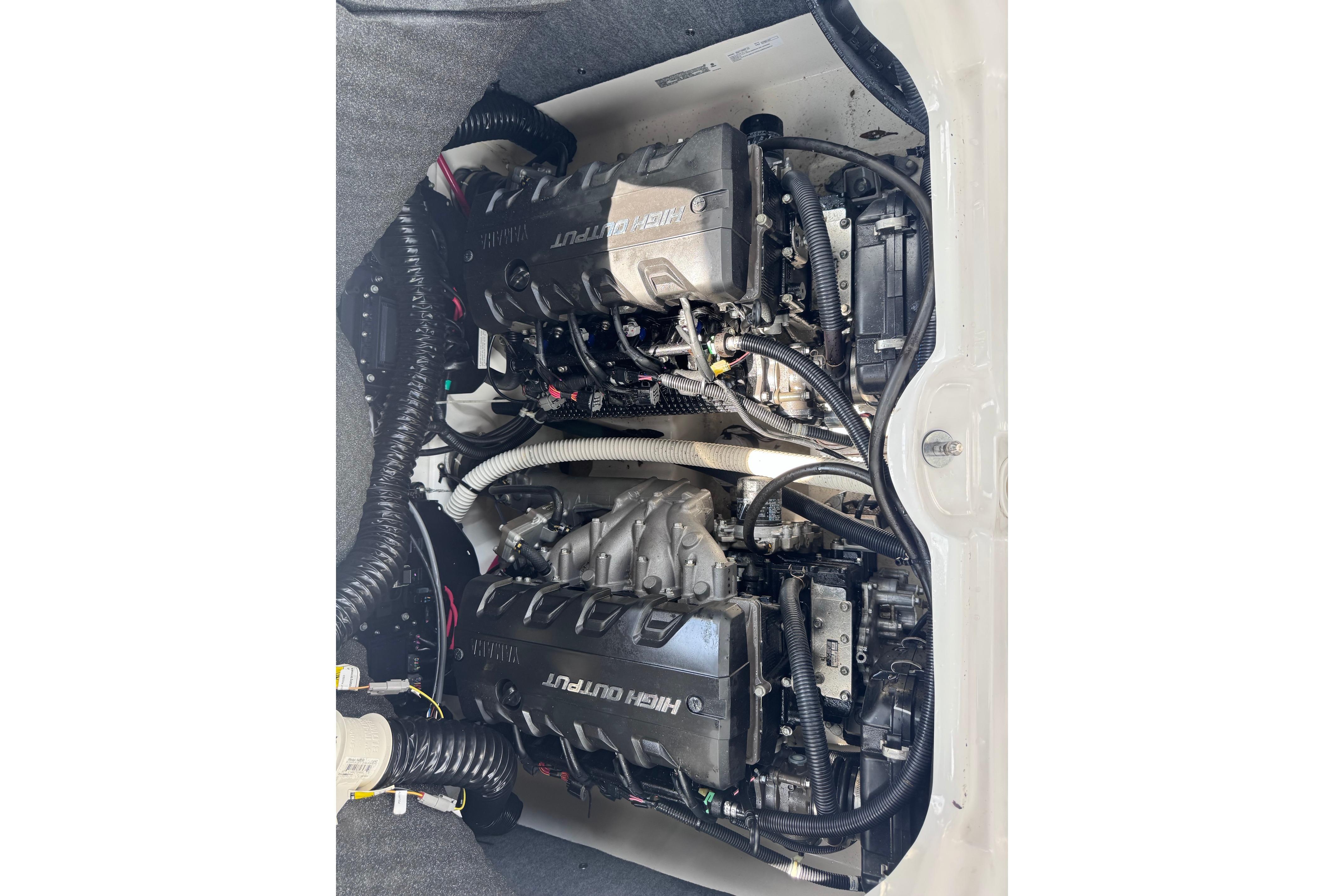 2019 Yamaha Boats 242SE engine compartment showcasing dual engines and intricate wiring.