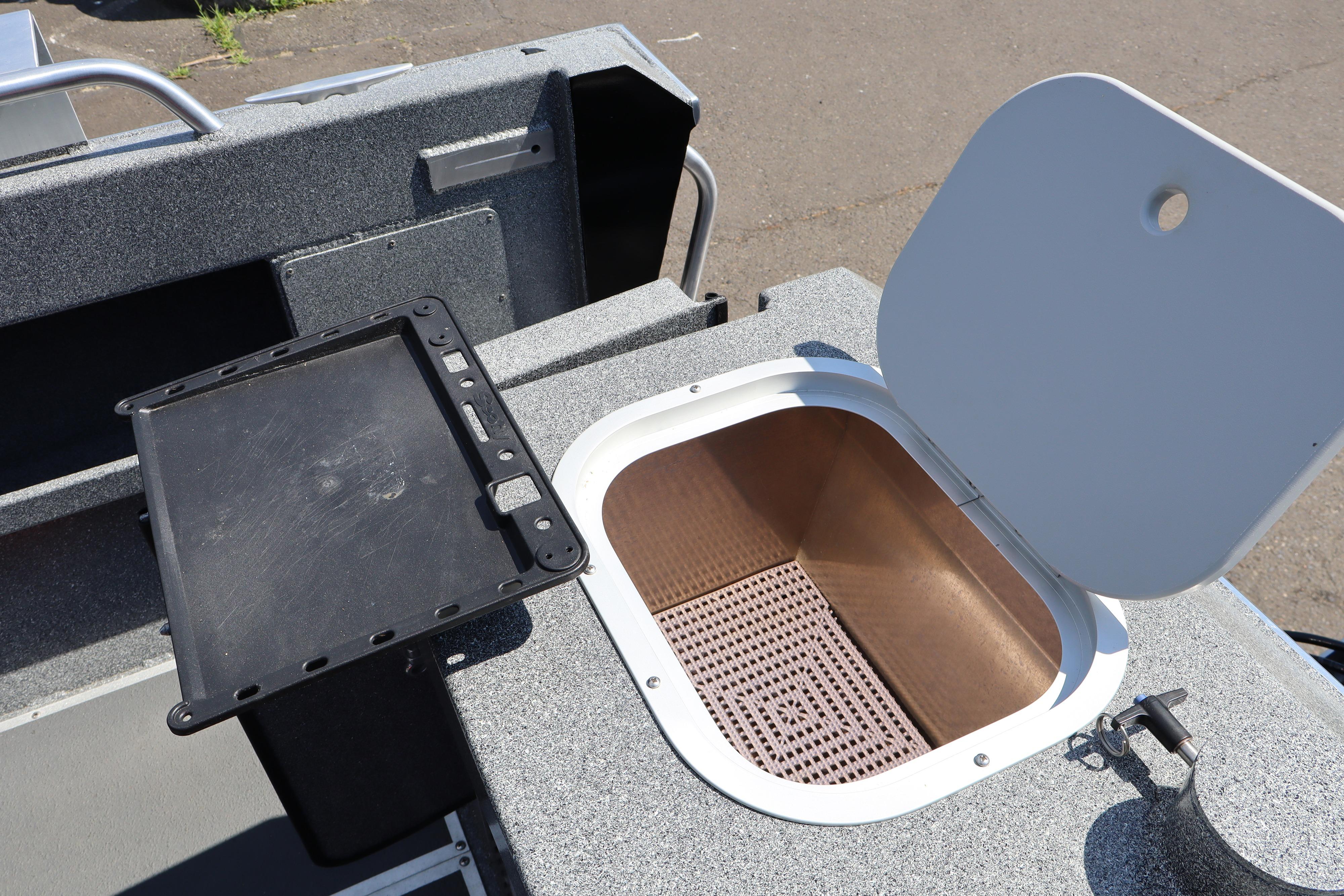 Open storage compartment on 2025 NorthRiver SEAHAWK boat, featuring a durable interior design.