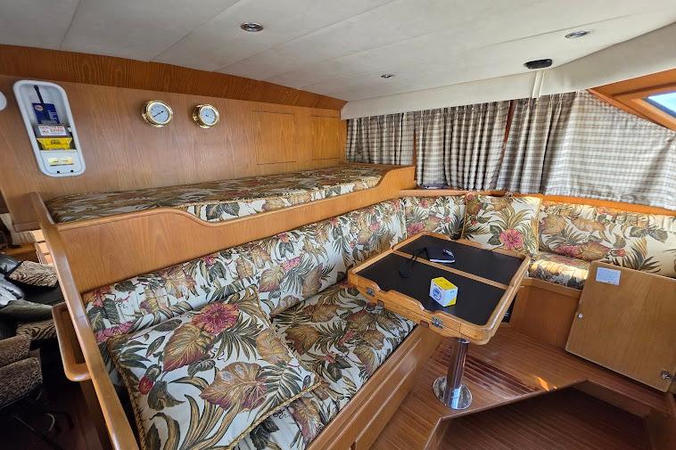 Interior of 1993 McKinna 48 Pilothouse with floral upholstery and wooden accents.