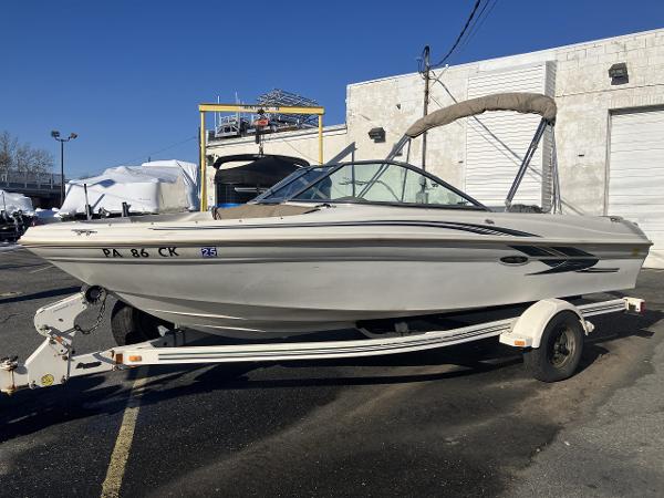 2001 Sea Ray 180 Bow Rider boat on trailer, parked outdoors.
