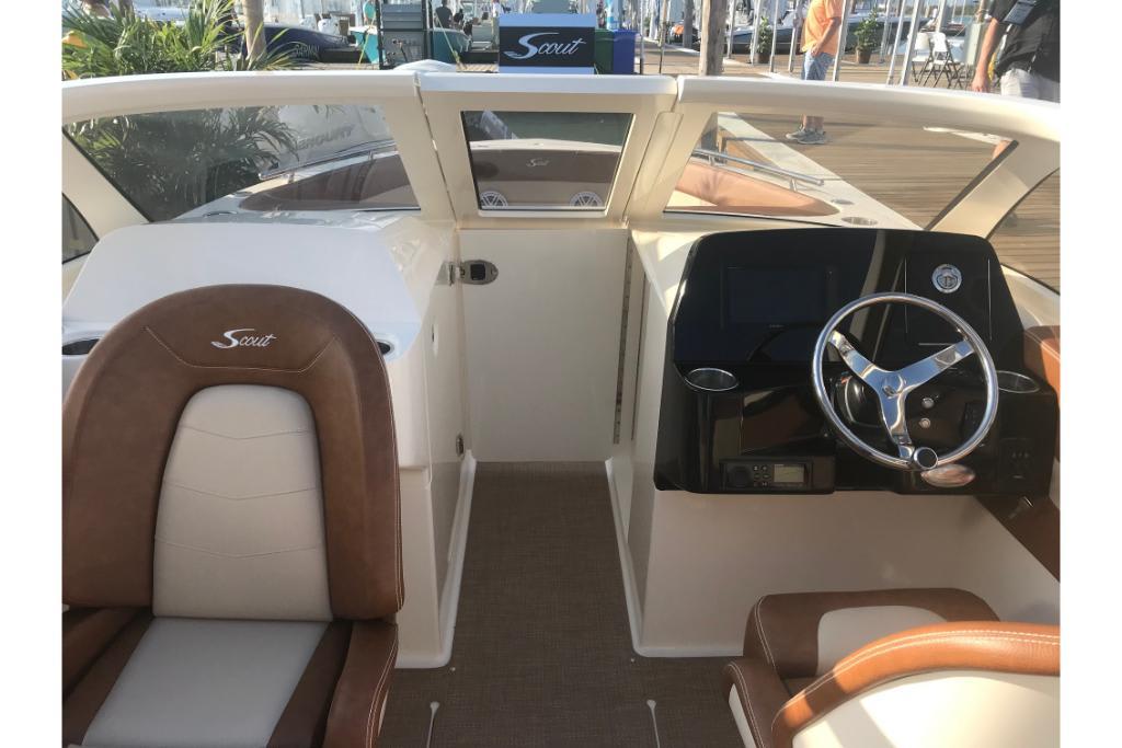 2023 Scout 240 Dorado boat interior with steering wheel and seating.