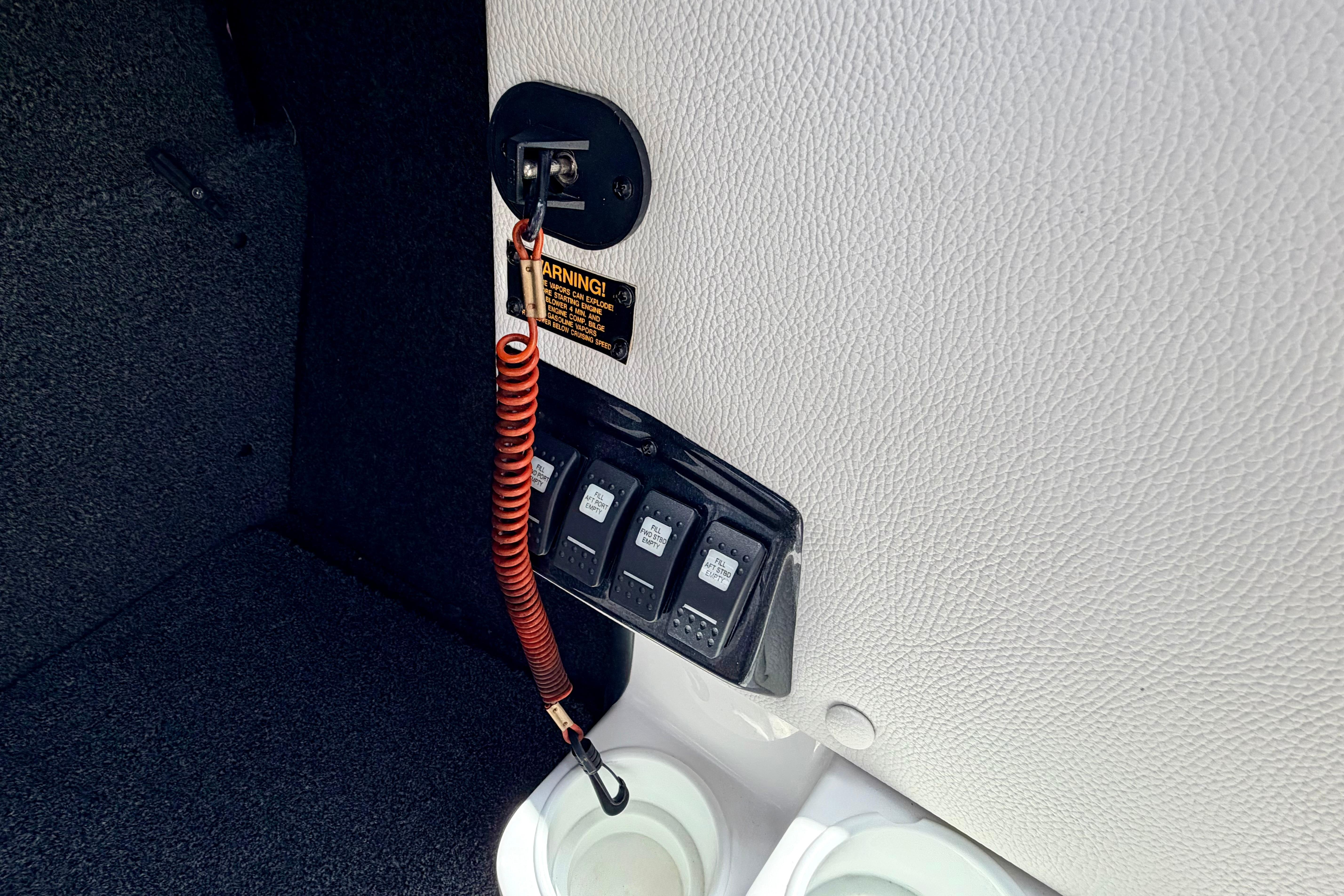 2014 Tigé R20 boat interior with safety lanyard and control switches.