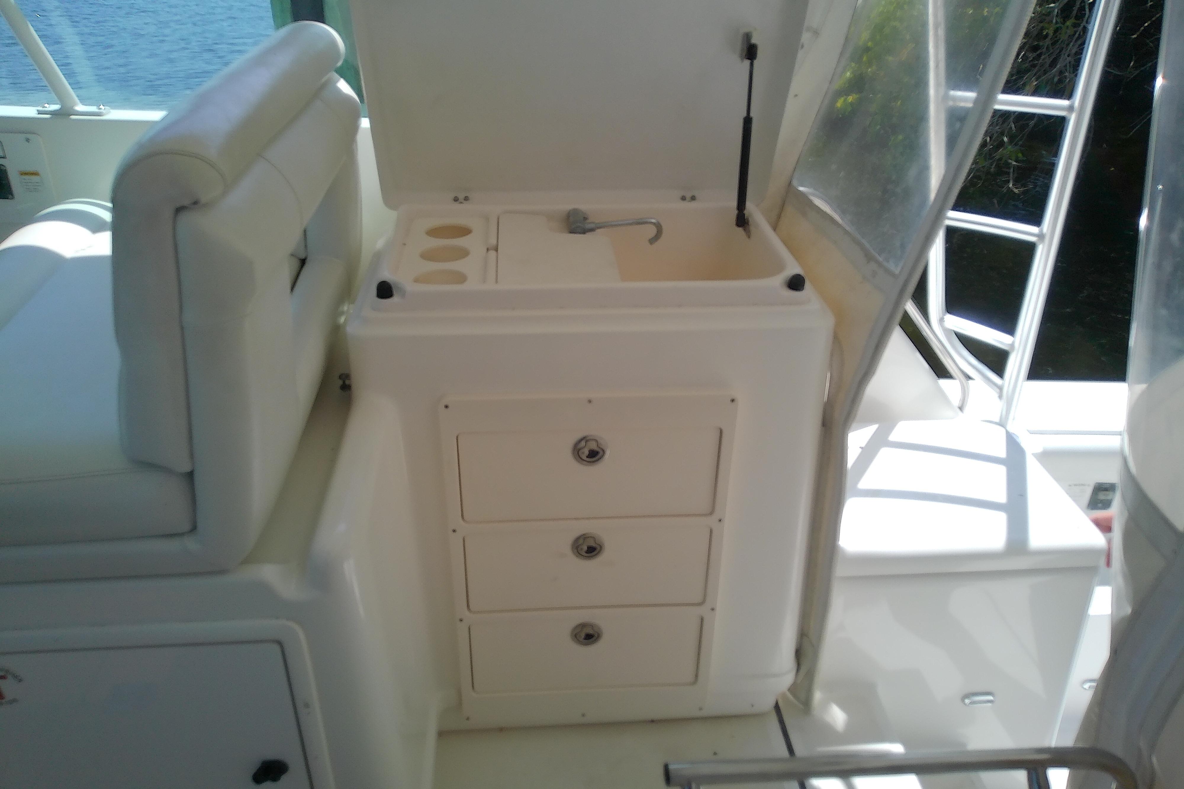 Interior view of a 2000 Tiara Yachts 4100 Open, featuring a compact sink and storage drawers.