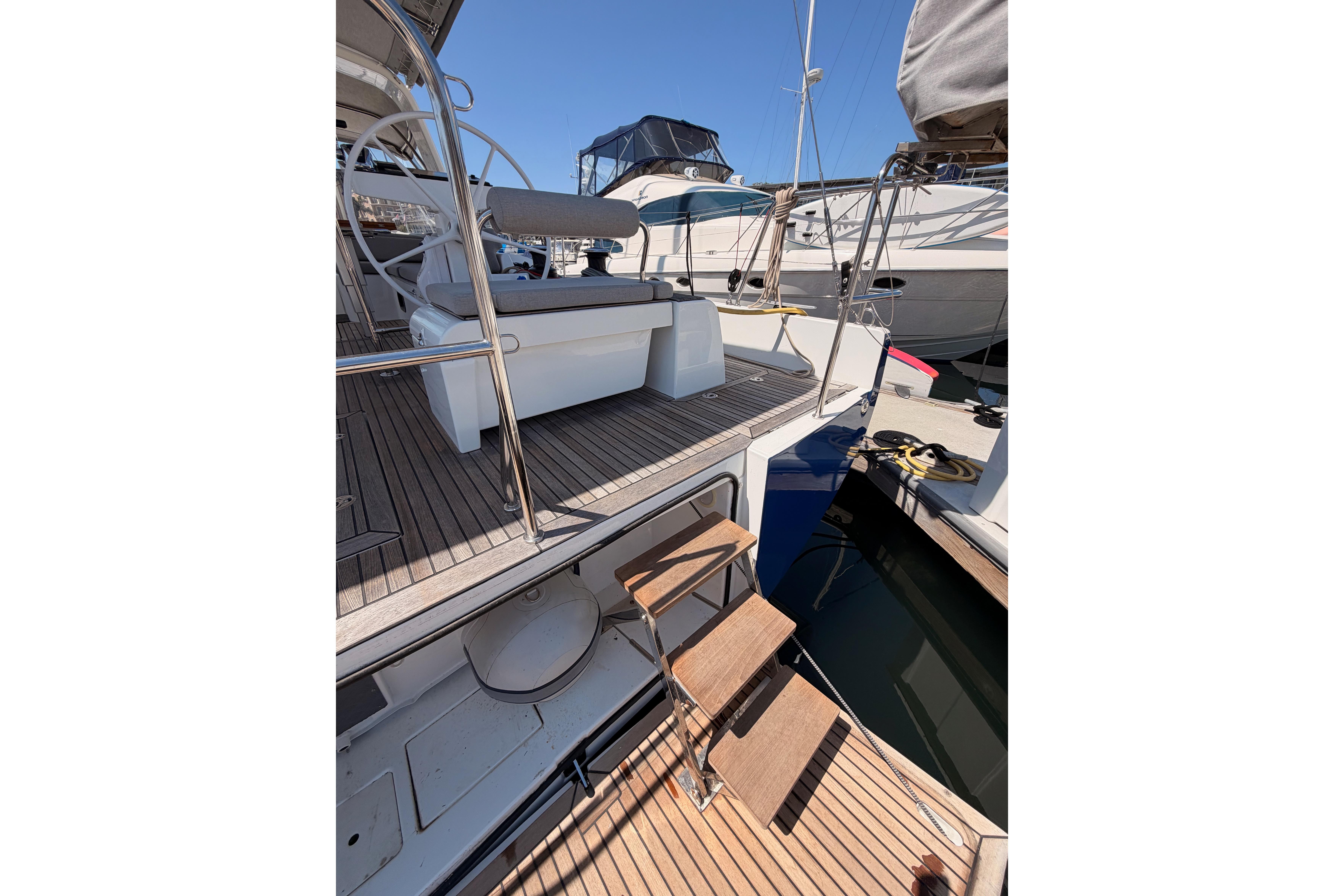 2022 Beneteau Oceanis Yacht 54 with teak deck and elegant cockpit design.