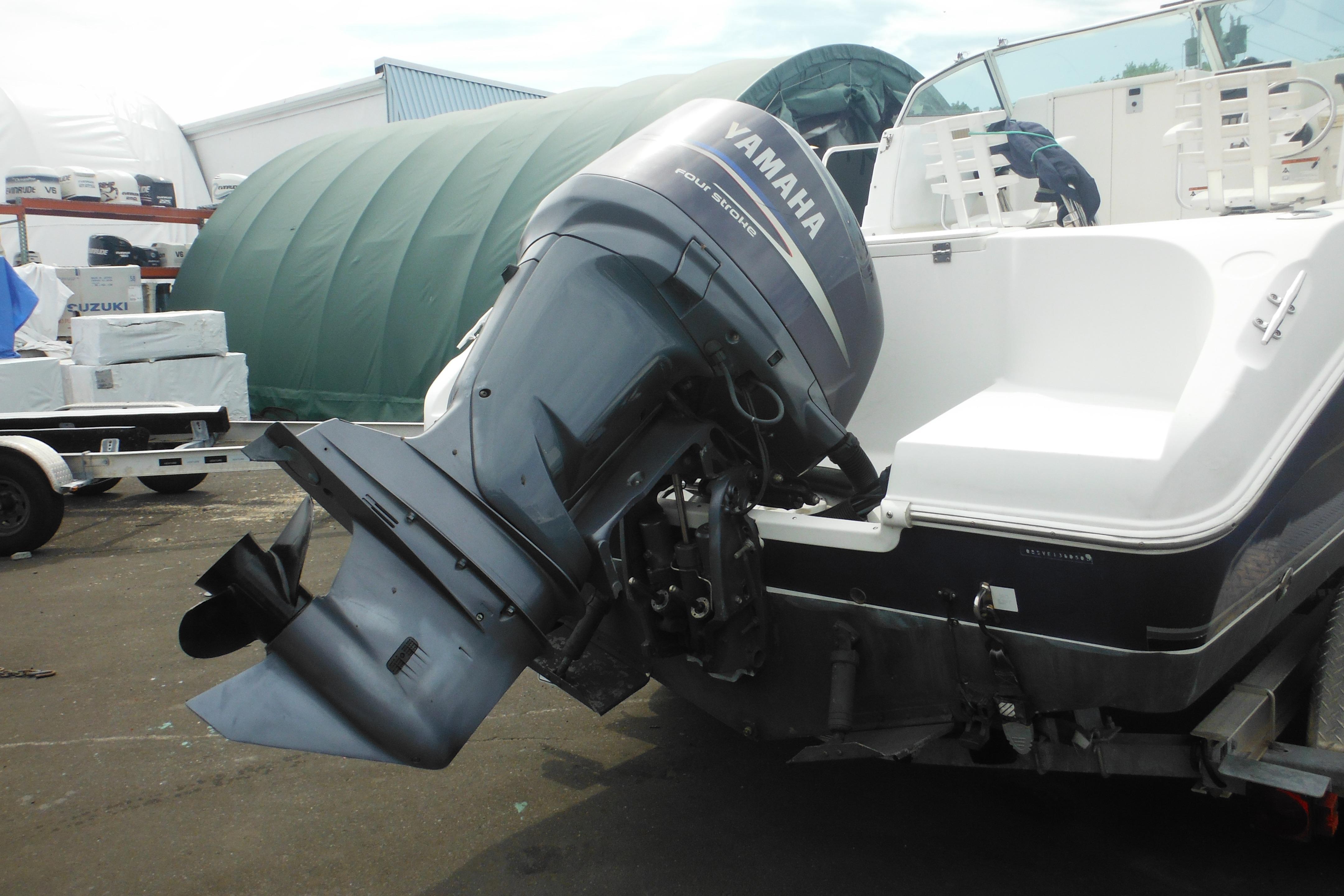 2005 Seaswirl Striper 2101 Walkaround O/B with Yamaha outboard motor in a boatyard.