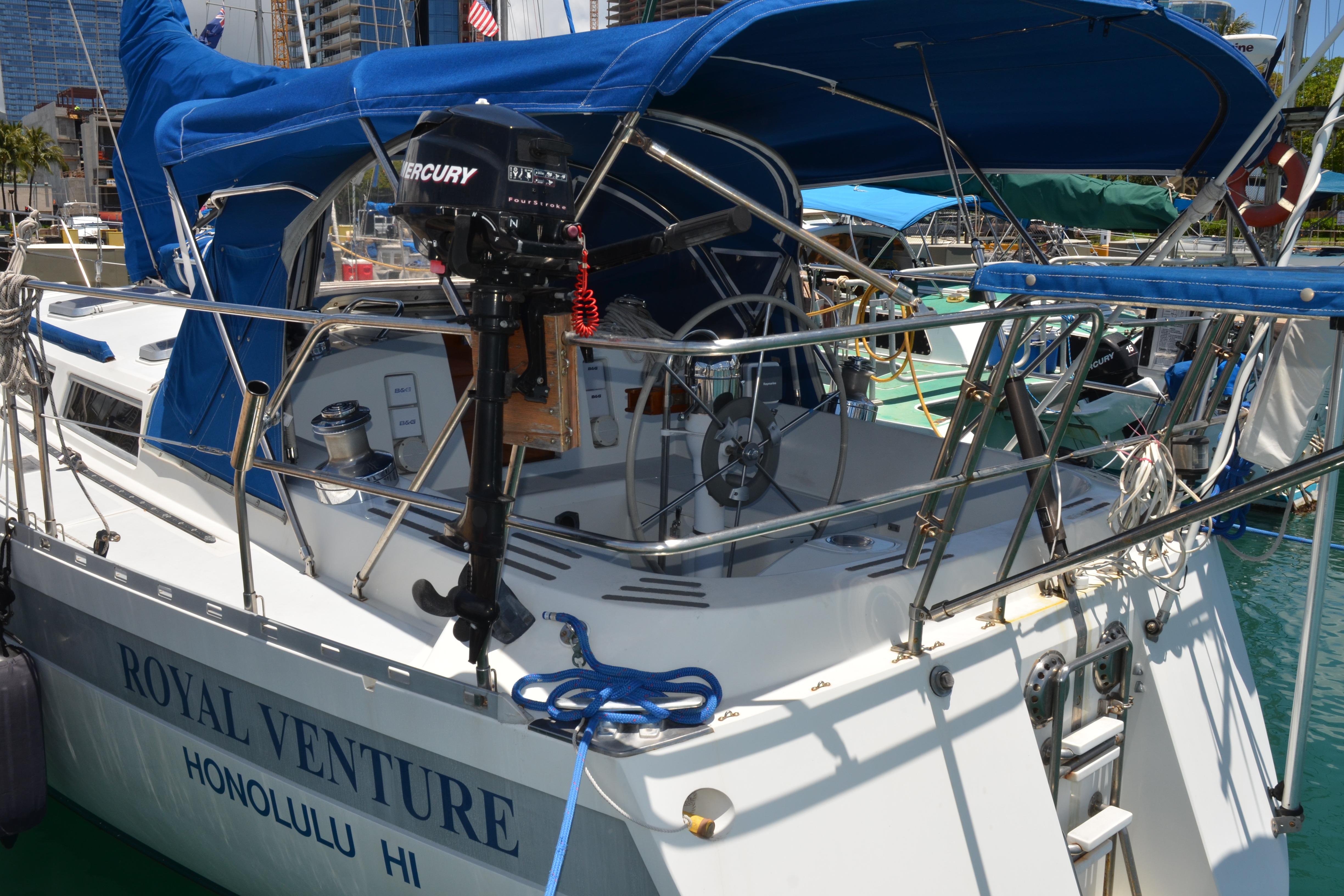 Sailboat "Royal Venture" docked in Honolulu, Norseman 400, 1987 model, with blue canopy.