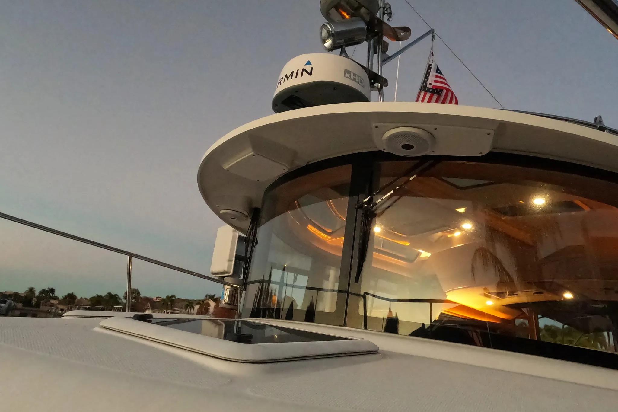2015 Ranger Tugs R-29 S boat with American flag and Garmin radar, sunset view.
