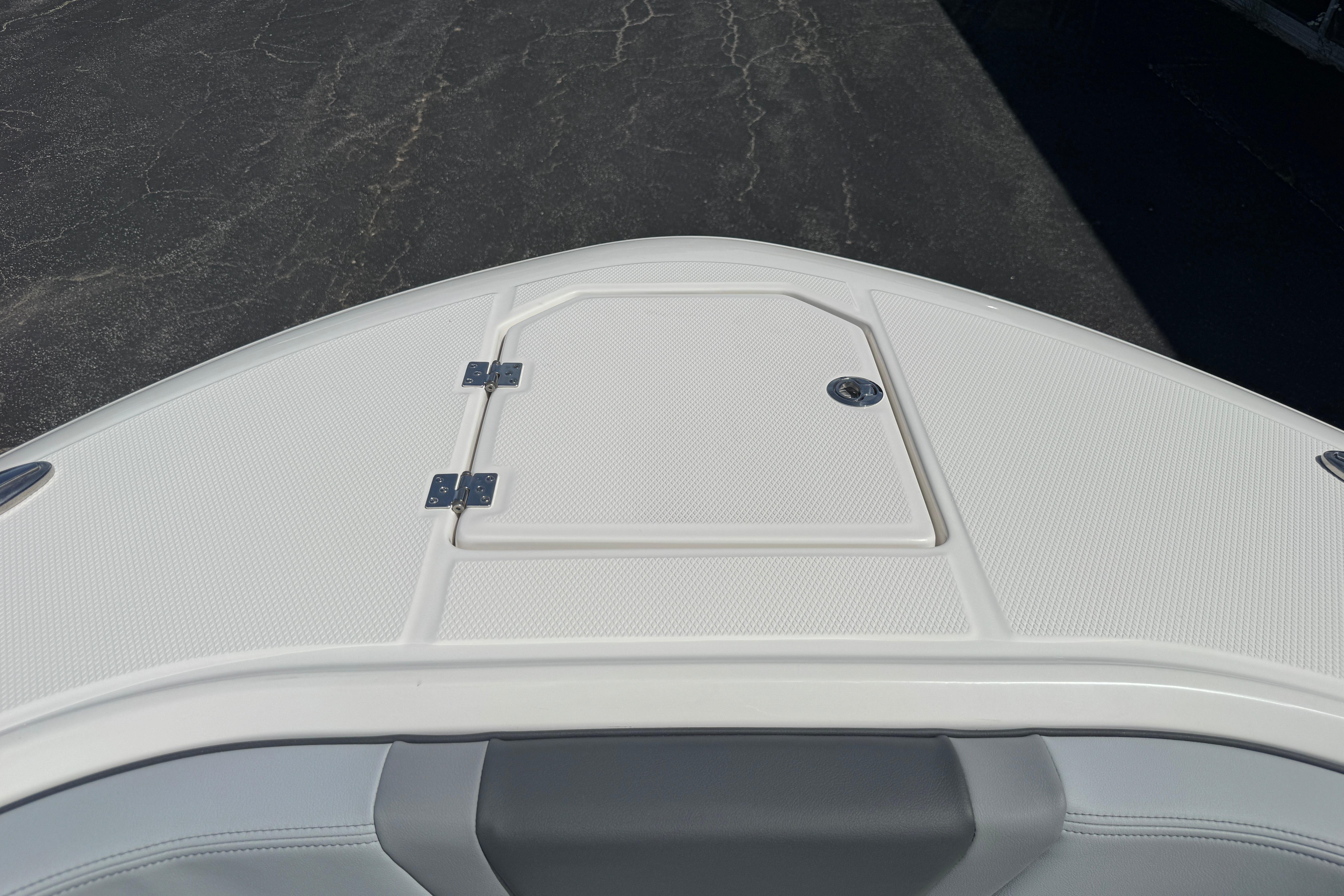 2026 Robalo R250 Center Console boat deck with storage hatch.