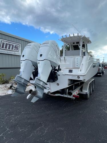 2014 Everglades 325 Center Console boat with dual outboard engines on a trailer.