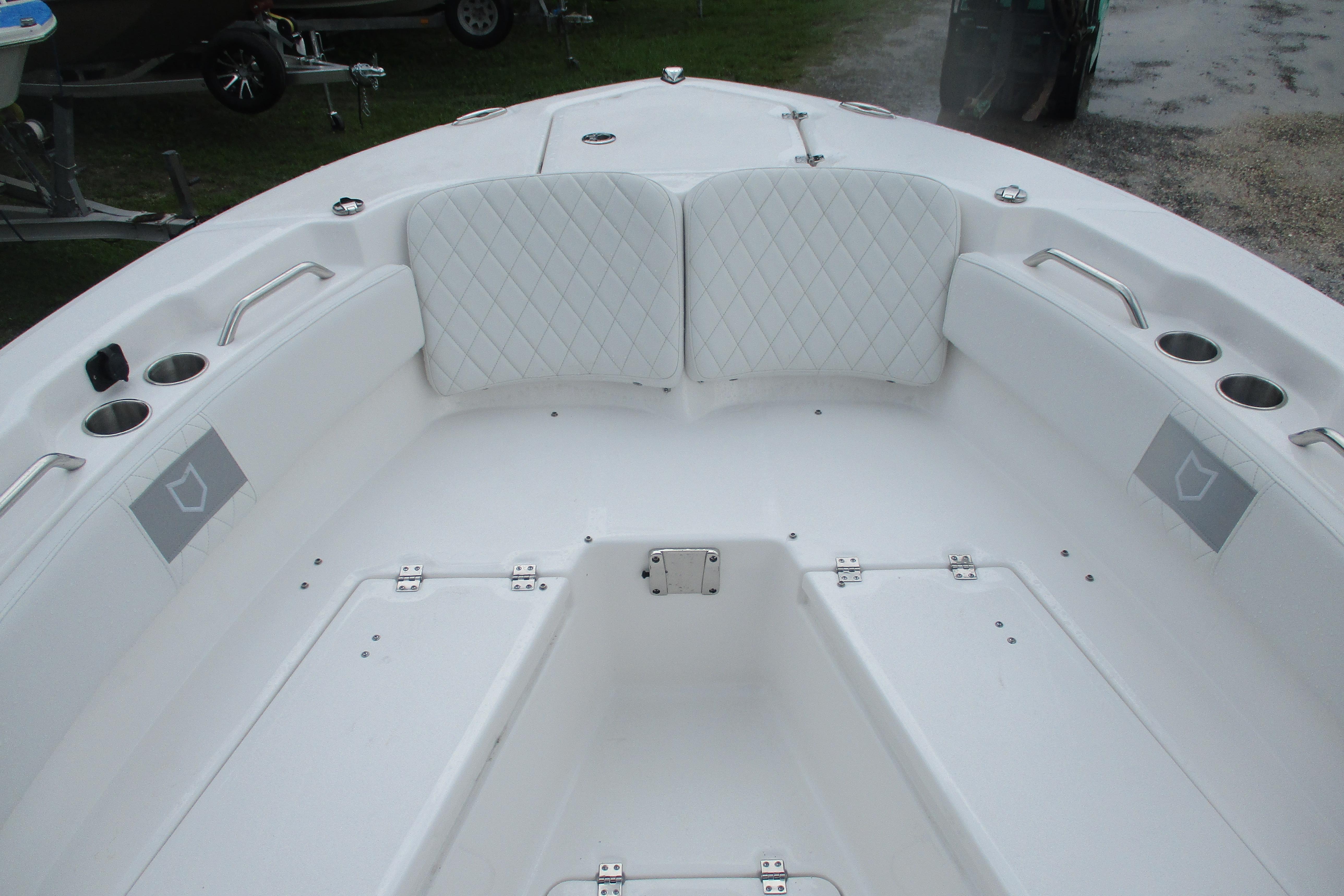 2026 Sea Fox 248 Commander boat interior with white seating and cup holders.