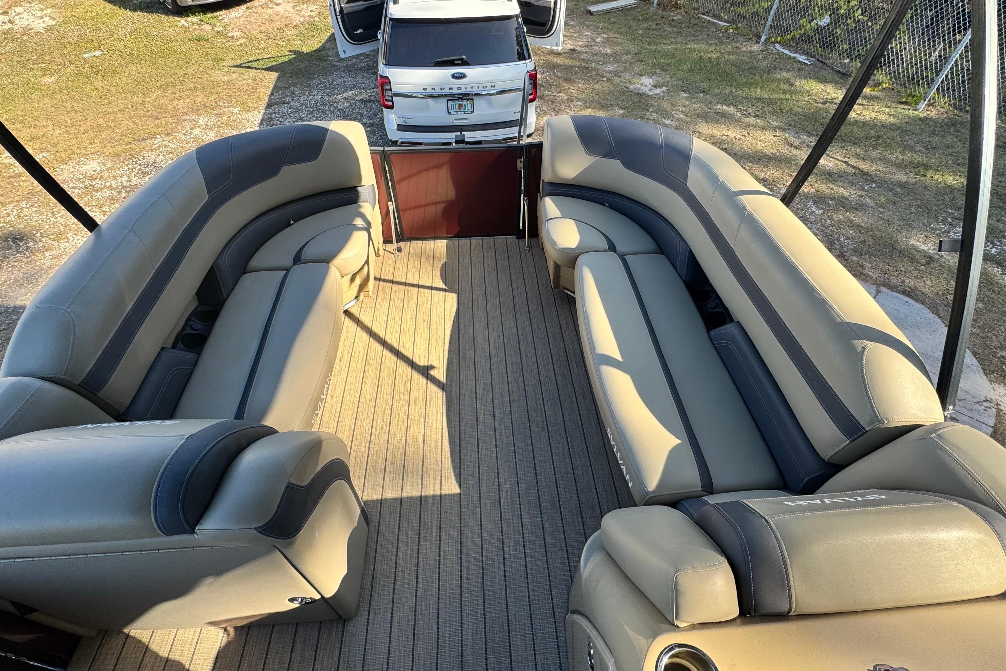 2023 Sylvan L5 CLZ pontoon boat interior with luxurious seating and open rear view.