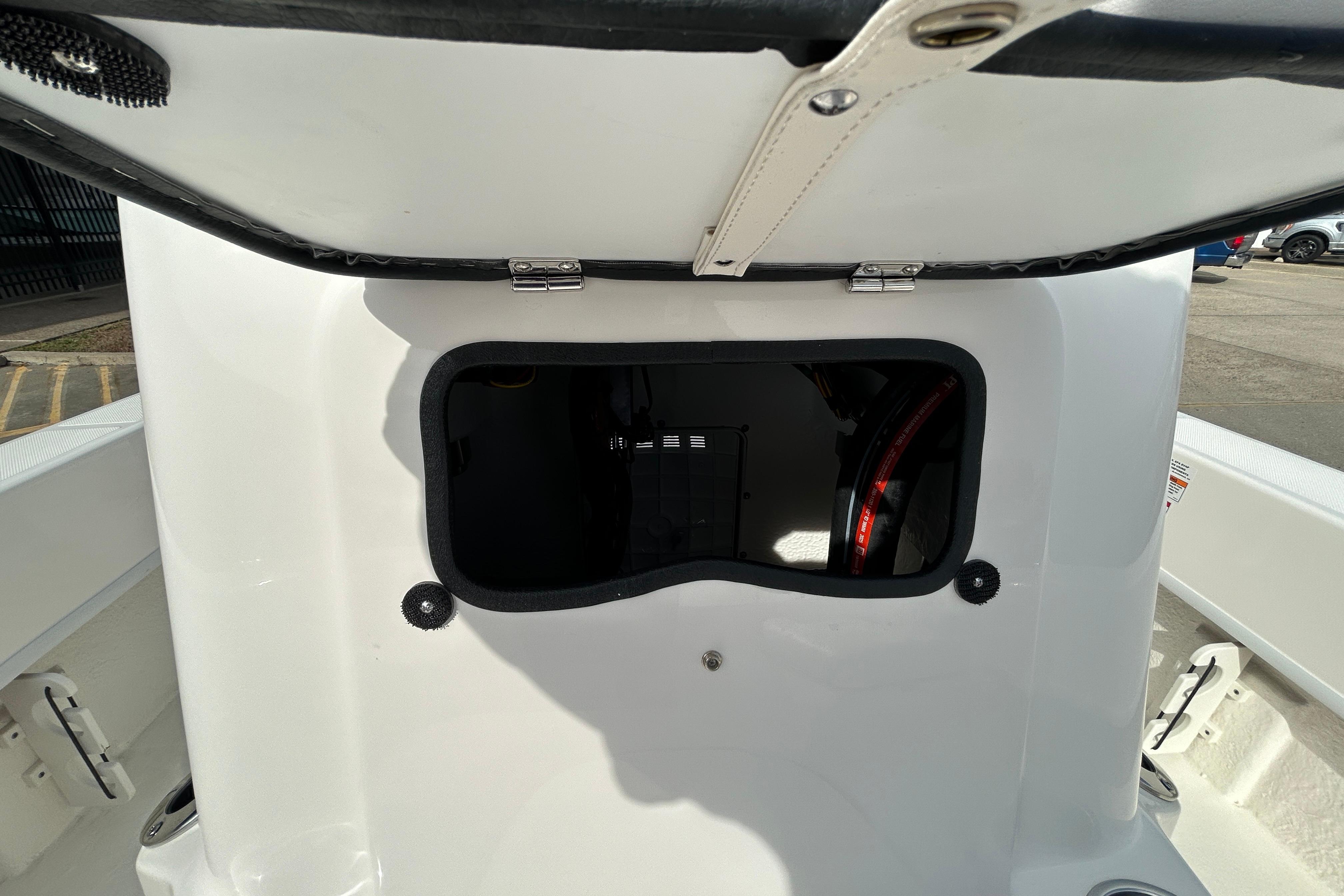 2026 Sundance B20CCR boat storage compartment with open hatch, showcasing interior details.