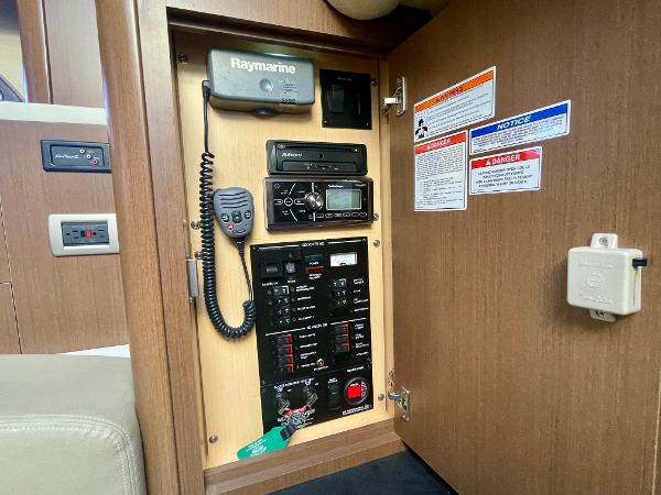 Control panel inside 2014 Sea Ray 330 Sundancer boat, featuring Raymarine equipment and safety notices.