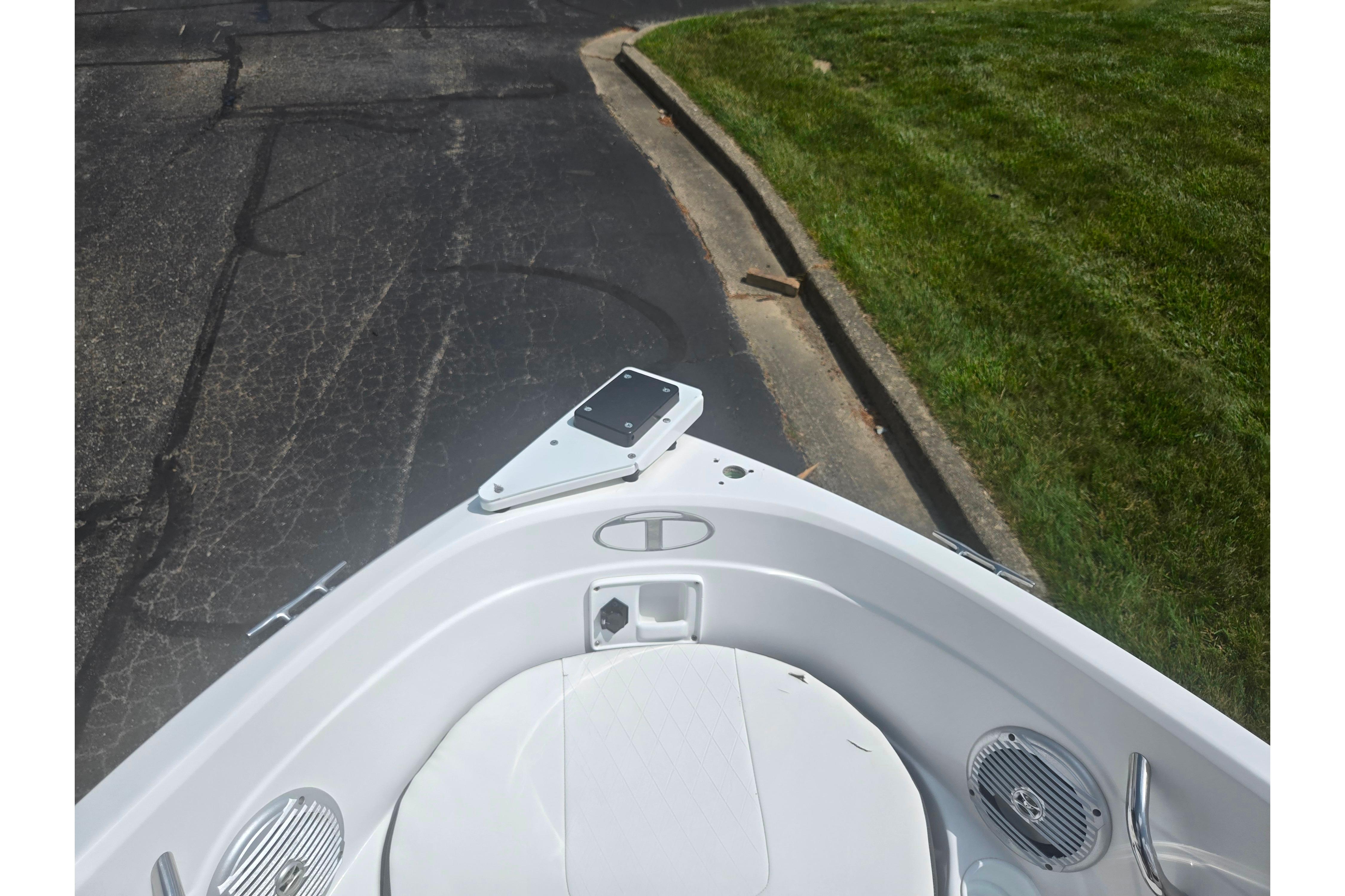 Bow of 2023 Tahoe 200 S boat on pavement near grass.