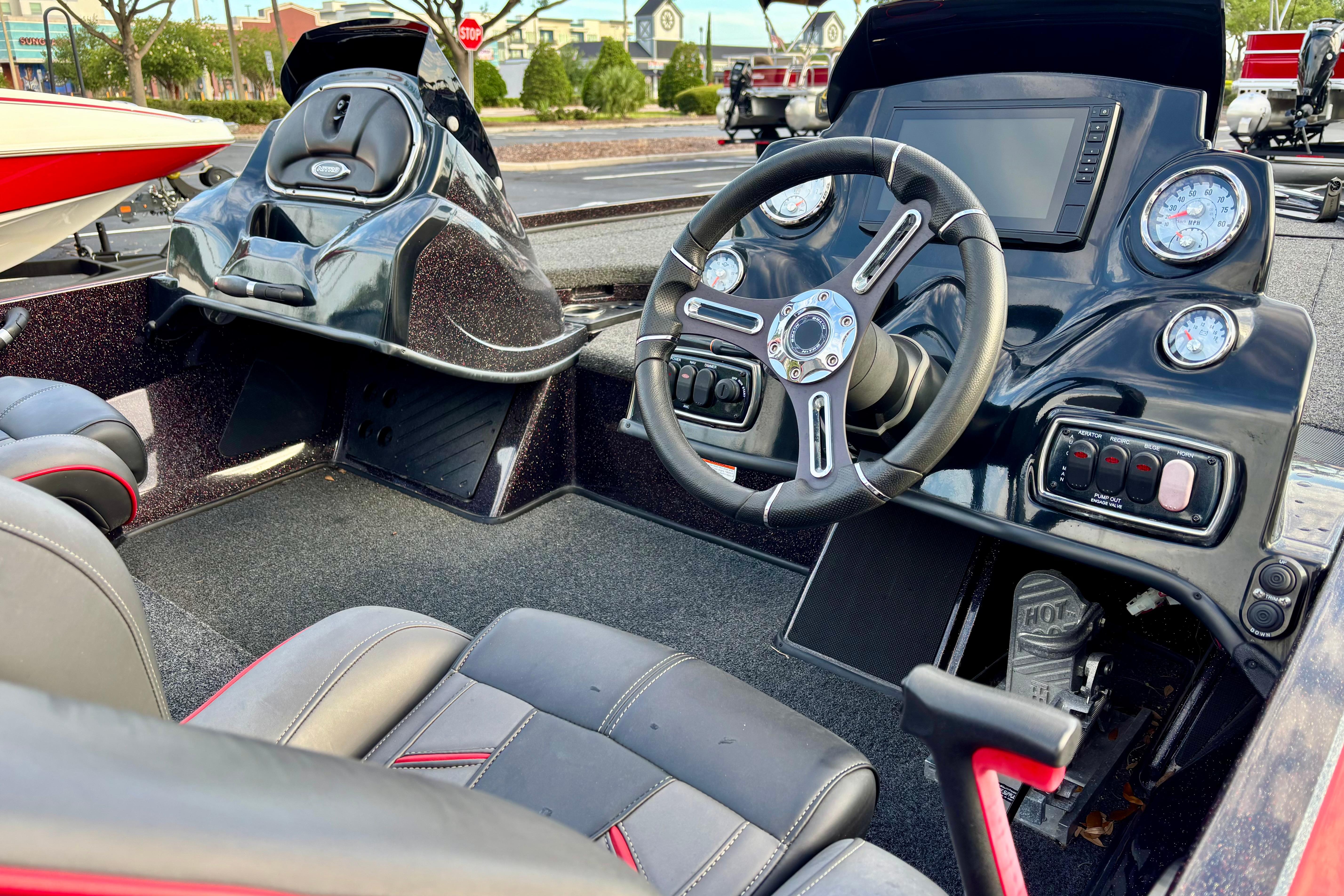 Interior of a 2018 Nitro Z18 boat featuring a sleek dashboard and steering wheel.