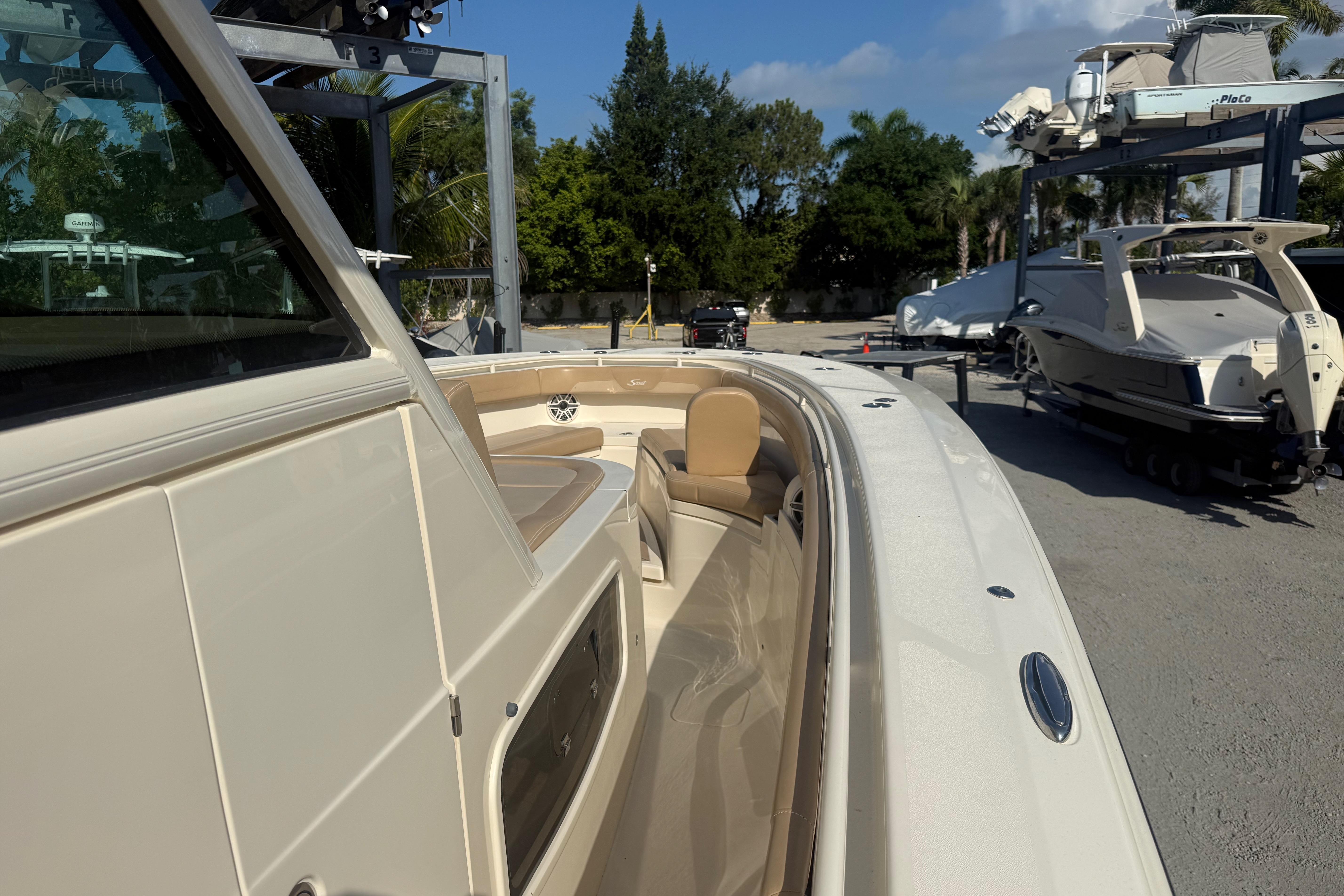 2022 Scout 355 LXF boat docked, showcasing sleek design and luxurious seating.