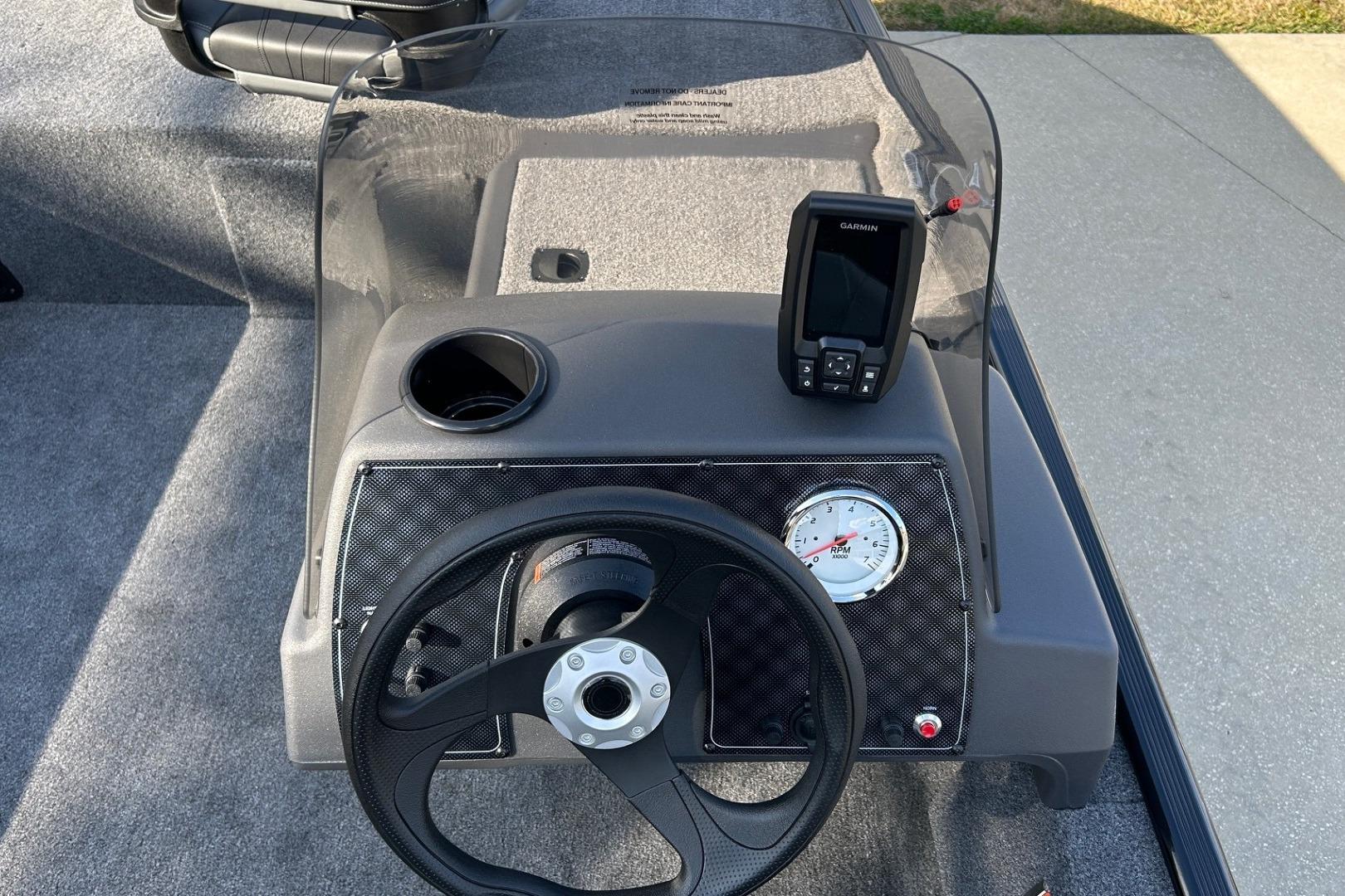 2026 Tracker Bass Tracker Classic XL dashboard with steering wheel and Garmin device.