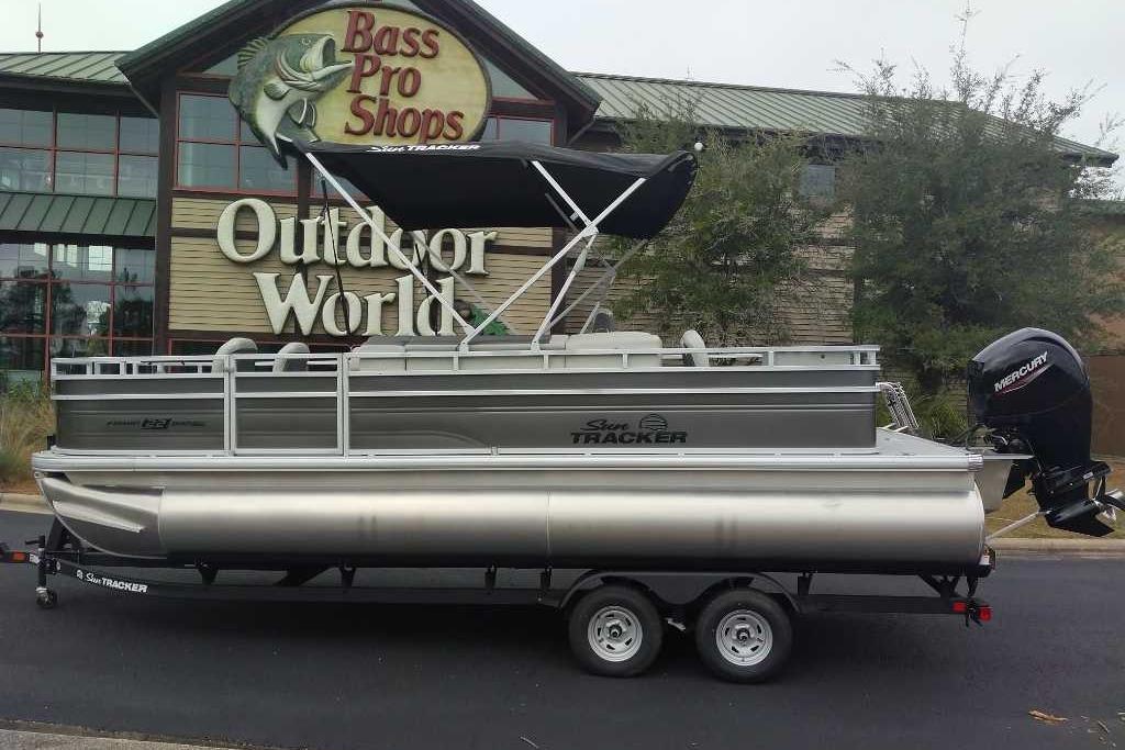 2026 Sun Tracker Fishin' Barge 22 DLX pontoon boat at Bass Pro Shops Outdoor World.