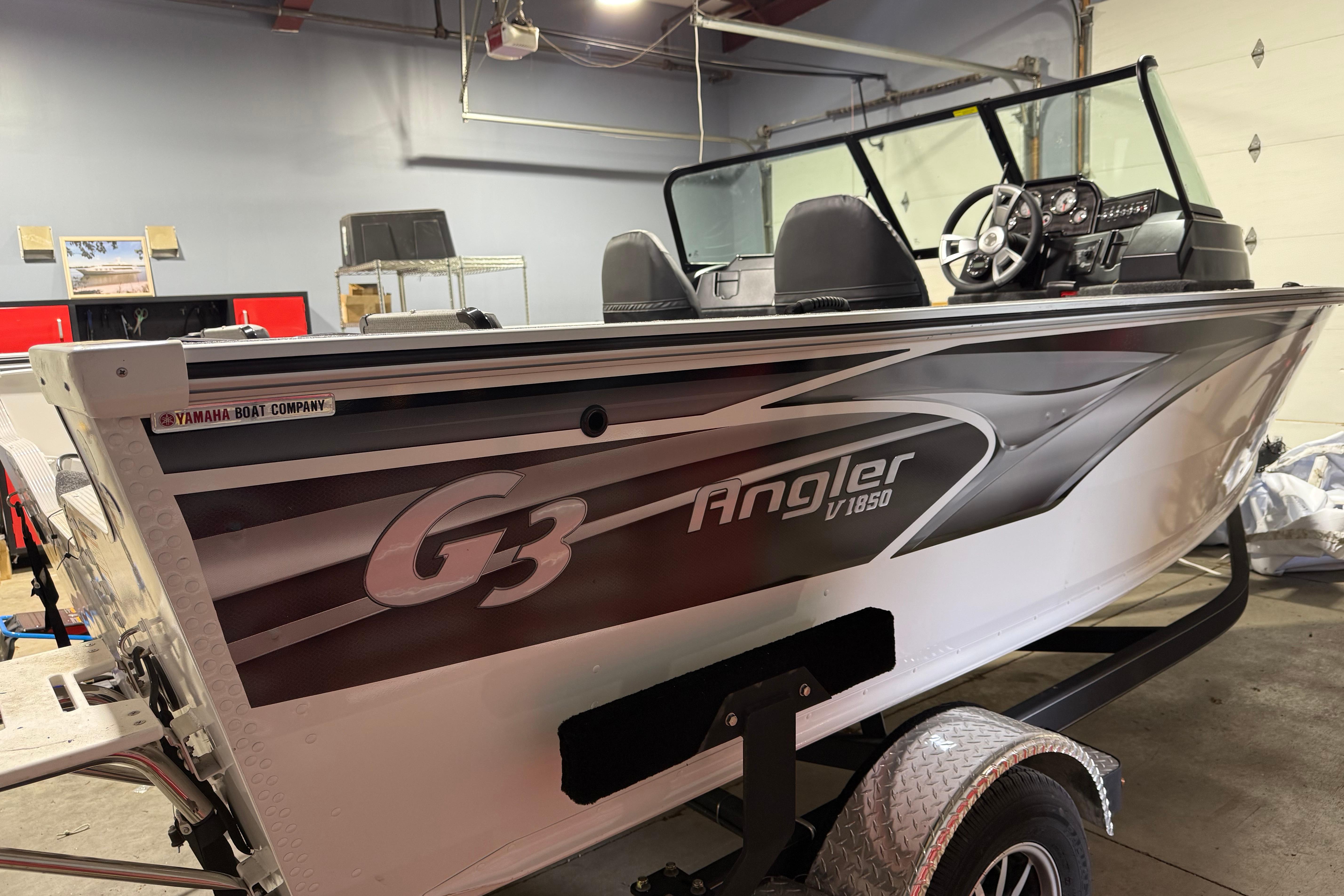 2025 G3 Angler V1850 SF boat in a garage, showcasing sleek design and modern features.