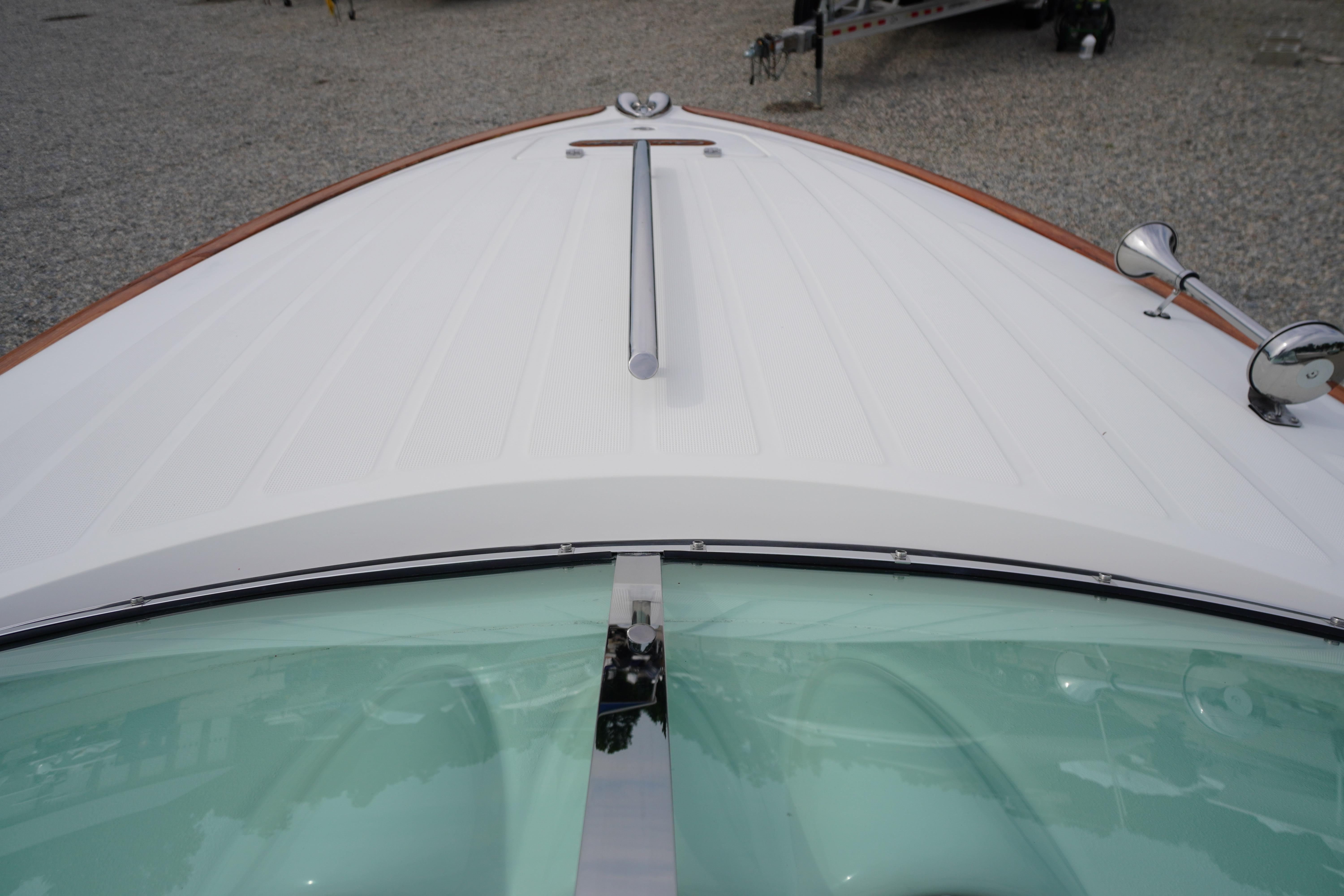 2005 Chris Craft Speedster Heritage boat with sleek white deck and chrome accents.
