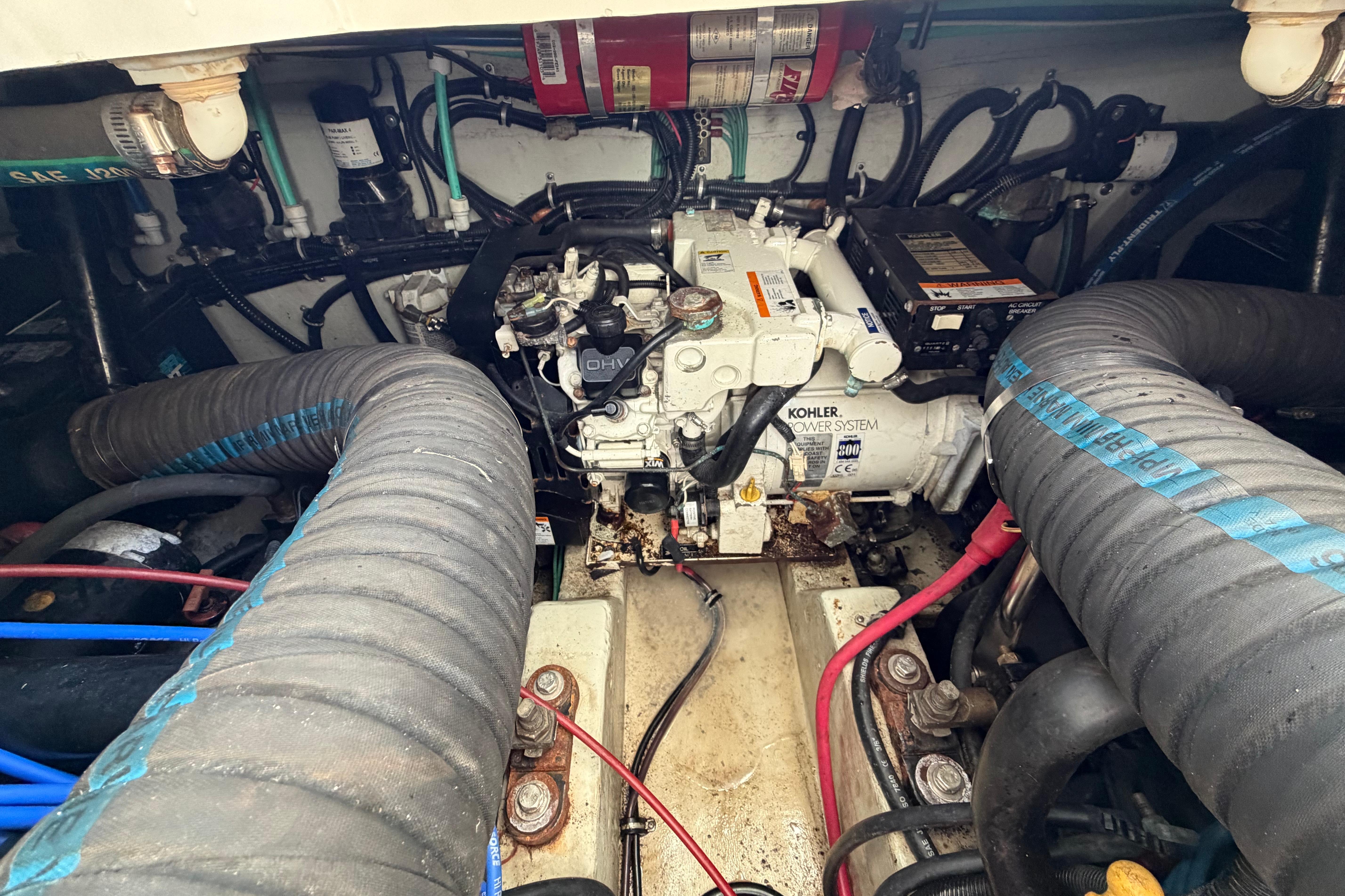 Engine compartment of a 2001 Pursuit 3000 Express boat, featuring Kohler power system.