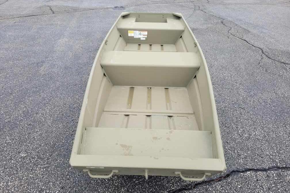 2026 Tracker Grizzly 14 Jon boat on asphalt surface, showcasing interior layout.