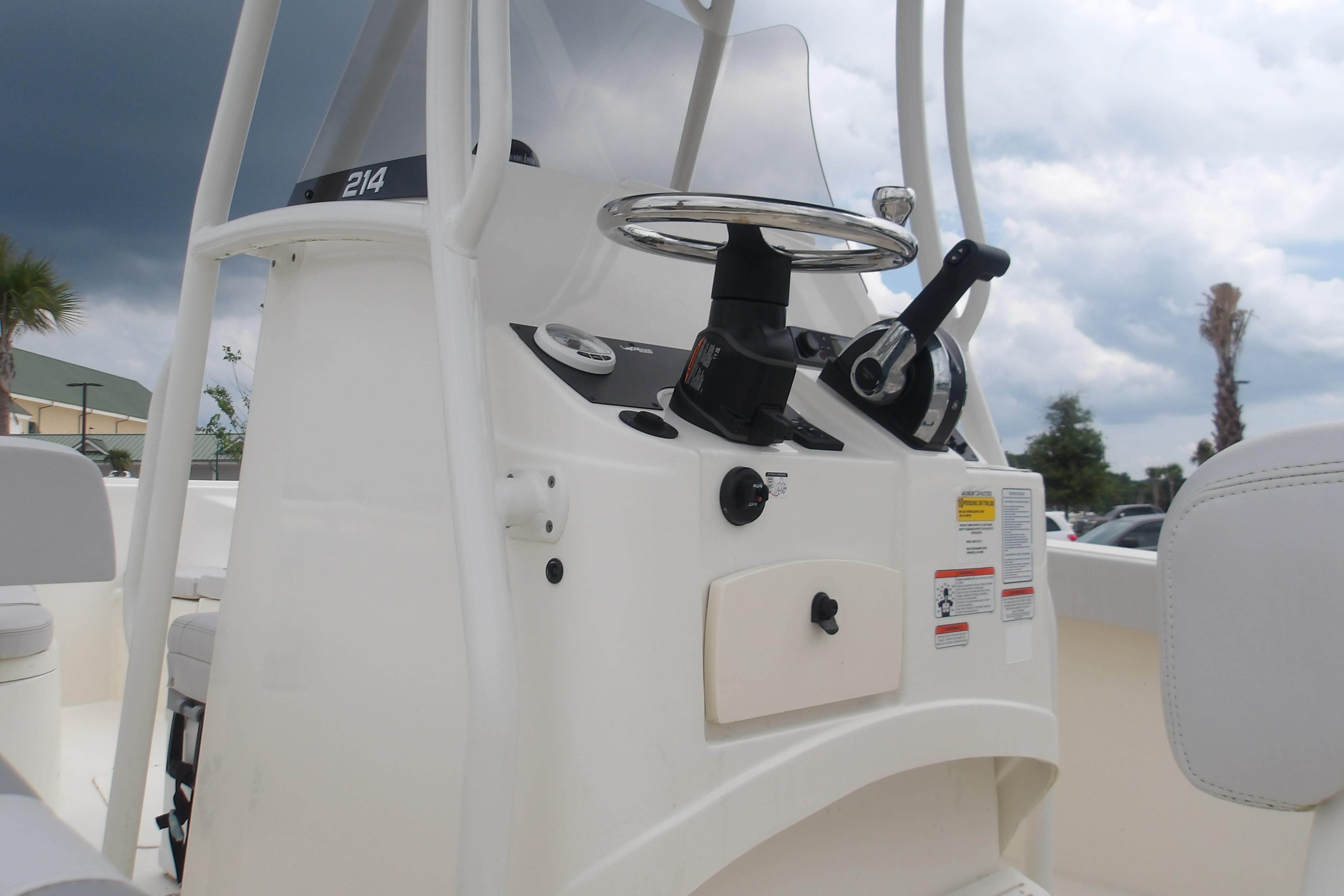 2025 Mako 214 Center Console boat dashboard with steering wheel and controls.